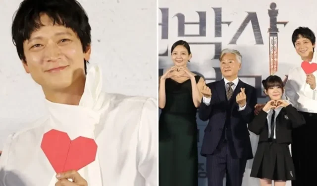 Kang Dong Won prepara argutamente un foglio a forma di cuore per le richieste di posa del cuore al recente evento