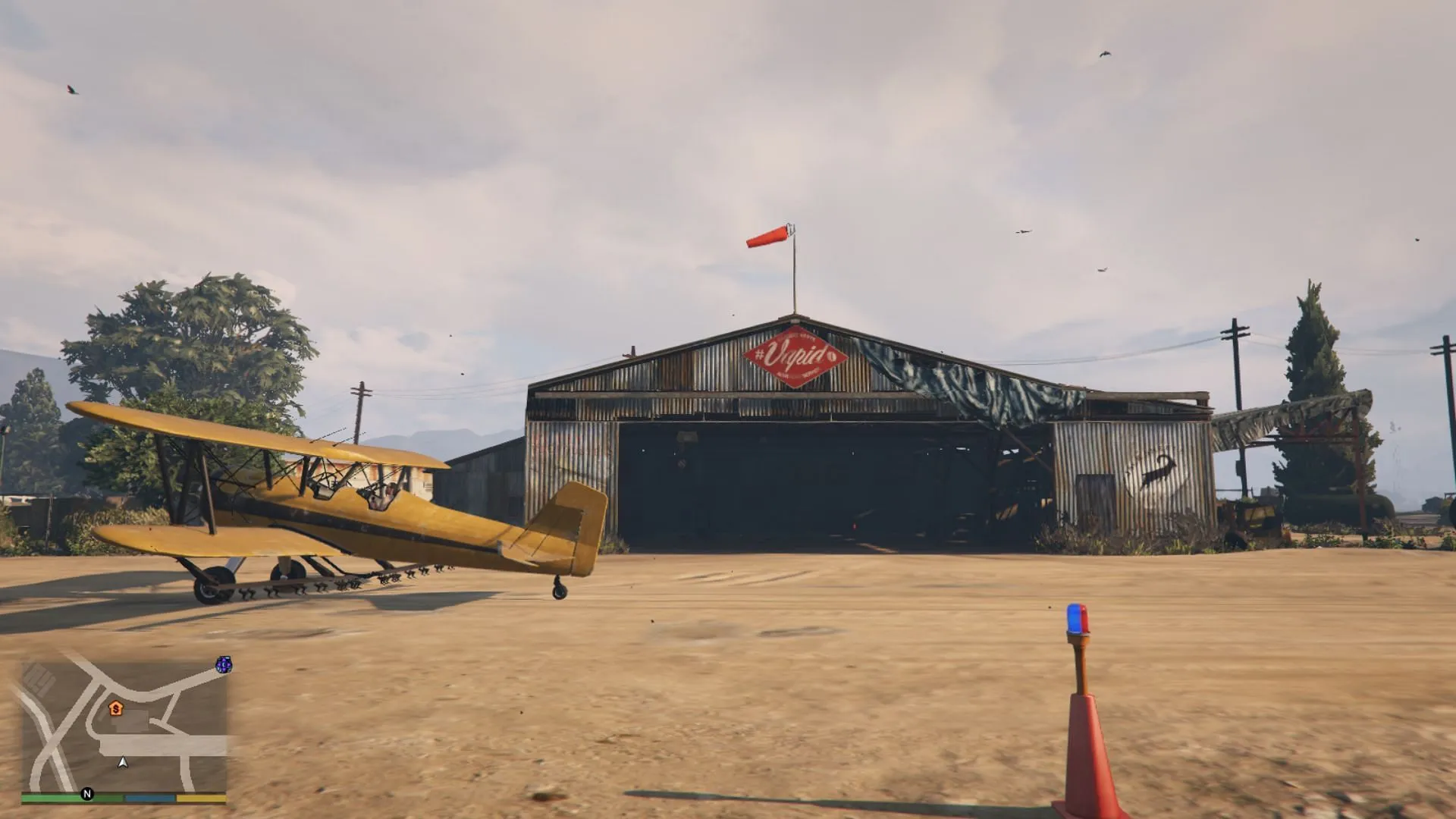 A screenshot of the McKenzie Field Hangar in Grand Theft Auto 5 Story Mode (Image via Rockstar Games)