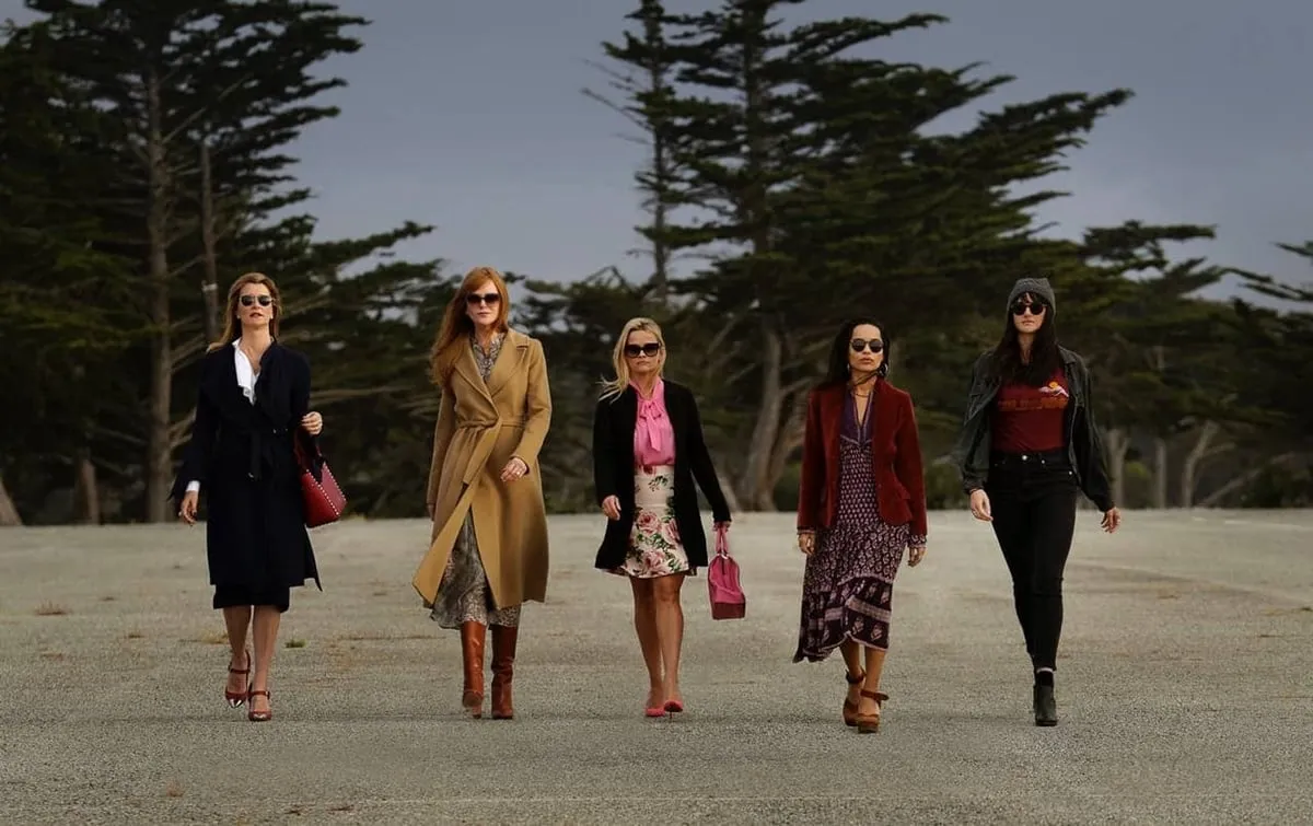 Five women walk purposefully along the beach