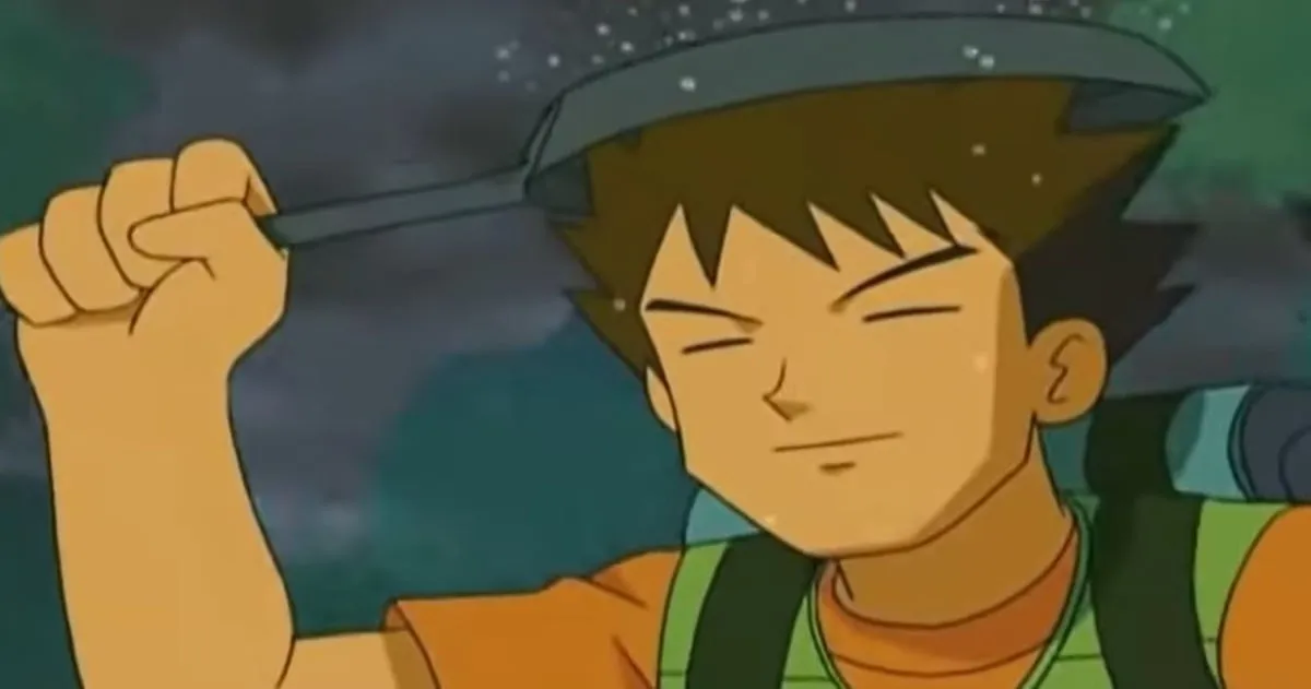 Brock stands in the rain with a frying pan over his head in