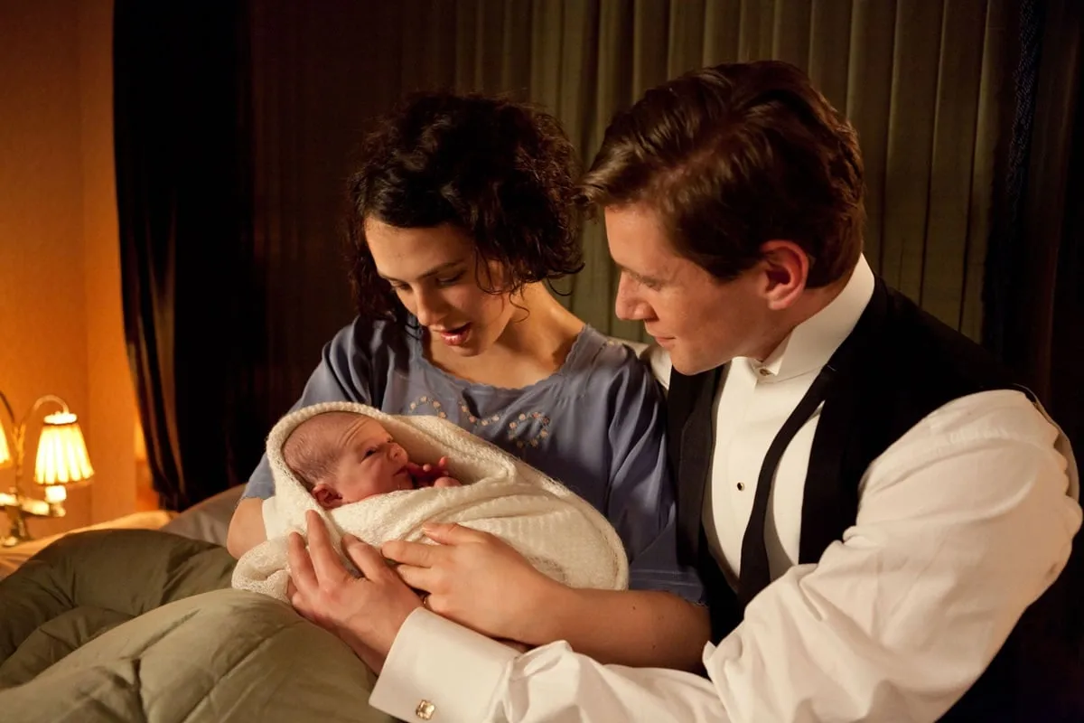 Sybil and Branson look at baby Sybbie