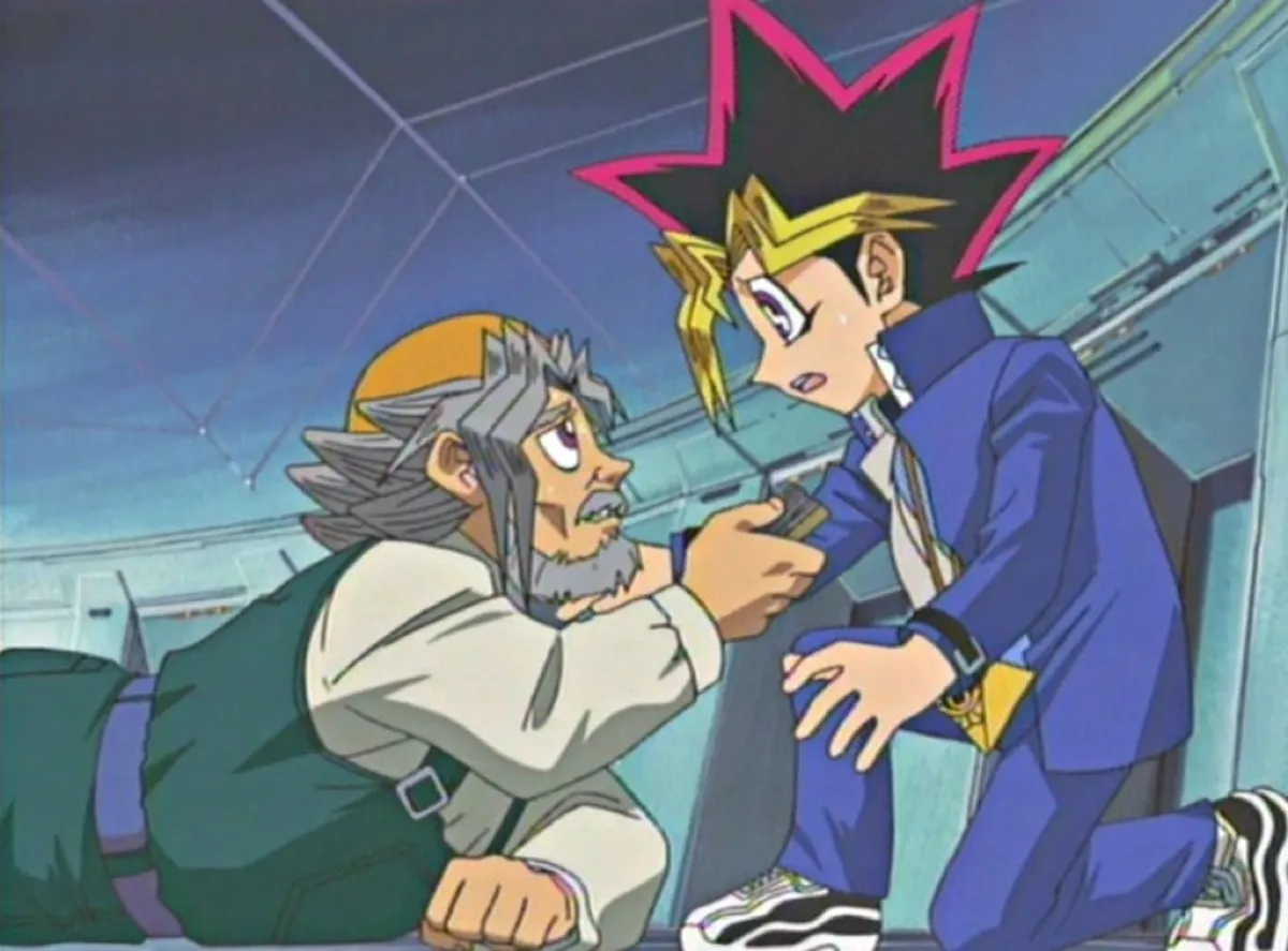 An elderly man falls to his grandson's feet in 'Yu Gi Oh'