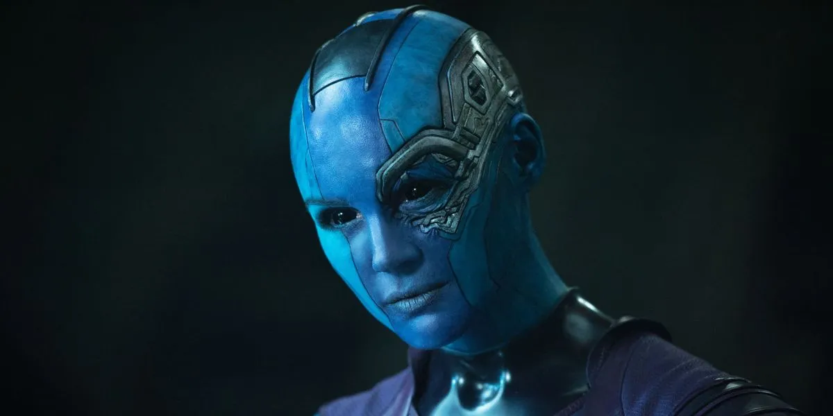 Nebula smirks at someone offscreen against a black background.