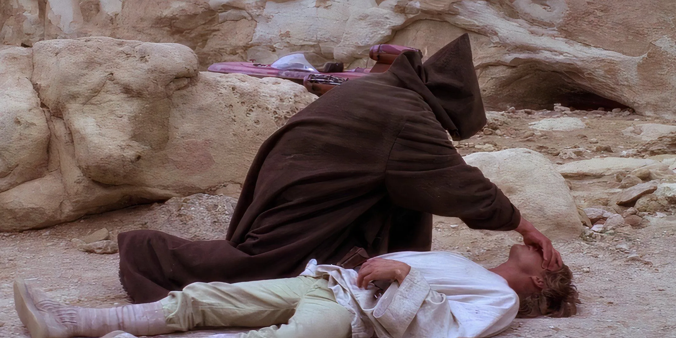 Obi-Wan placing his hand on Luke Skywalker's head in Star Wars A New Hope