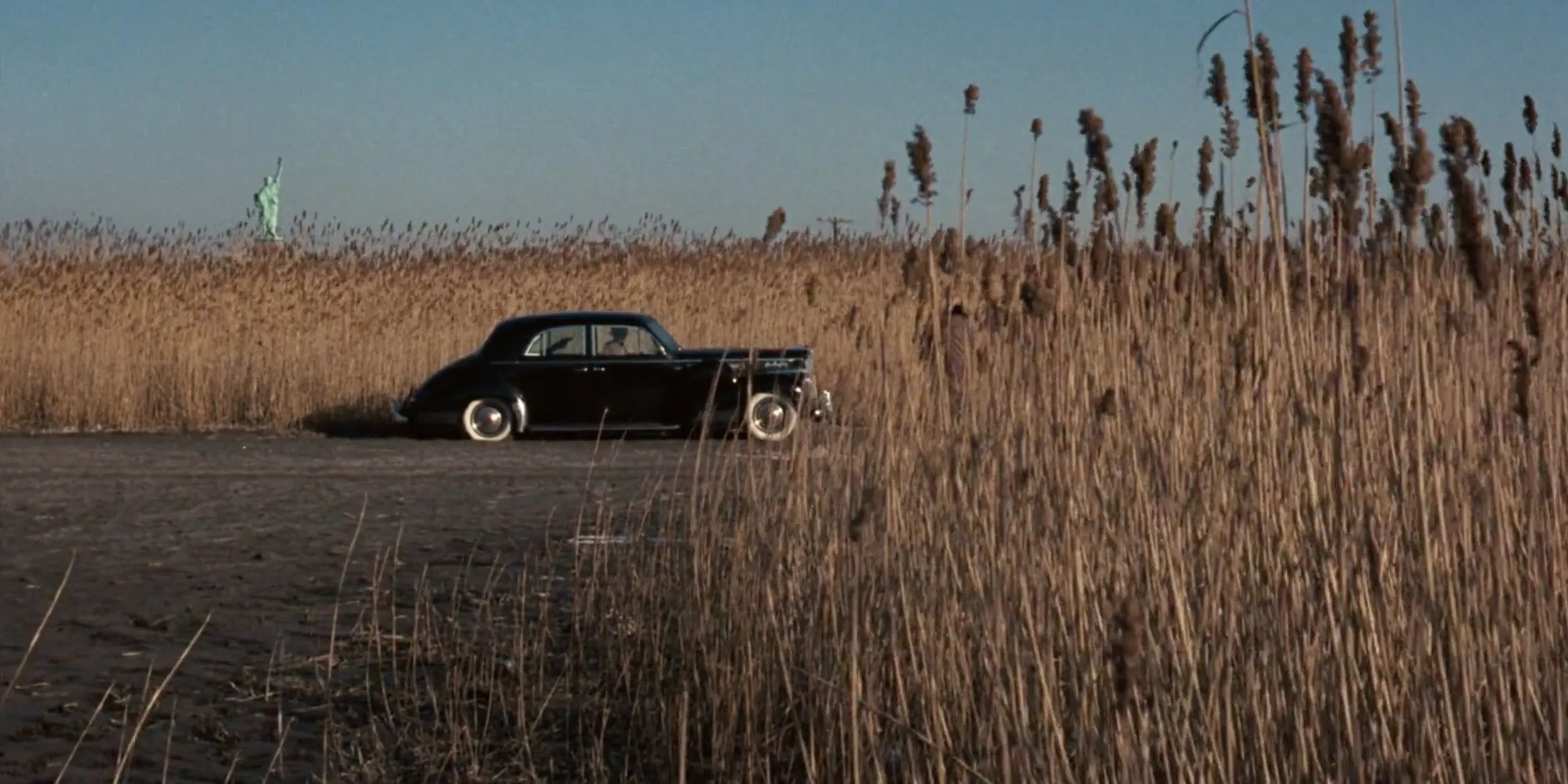 A mob hit with the Statue of Liberty in the background in The Godfather