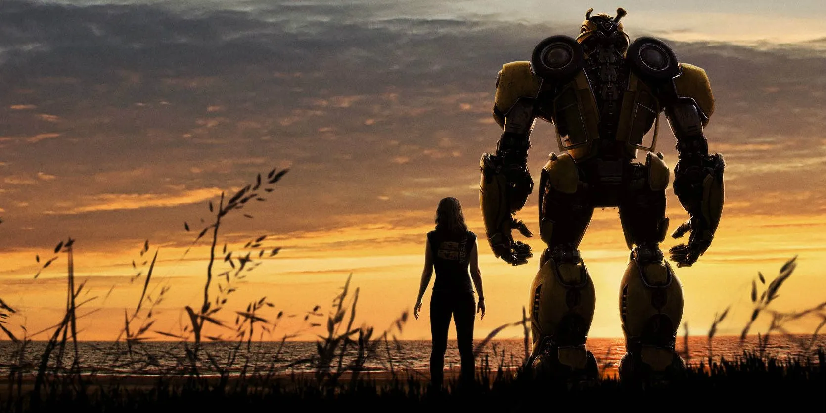 Charlie and Bumblebee looking out at a sunset in Bumblebee