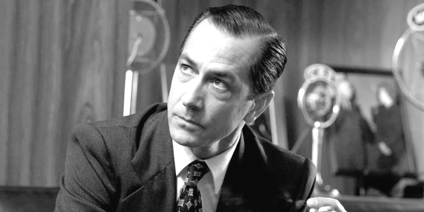 David Strathairn as Edward R. Murrow in Good Night, and Good Luck, looking suave and distinguished while smoking a cigarette in a radio studio