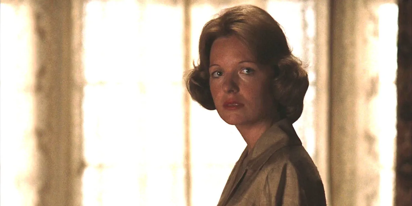 Diane Keaton as Kay in The Godfather looking slightly alarmed and disgusted standing in front of white curtains