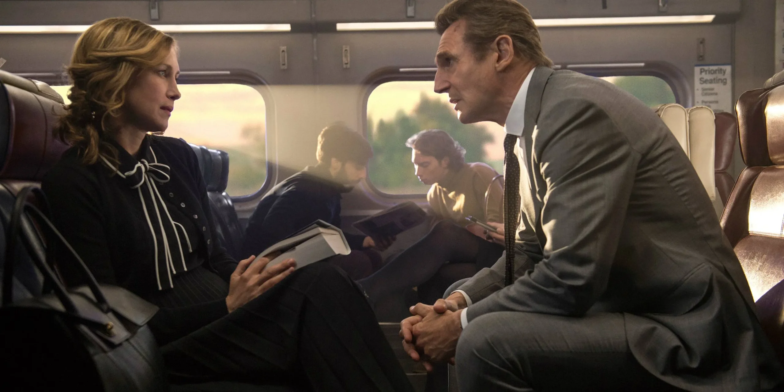 Vera Farmiga & Liam Neeson facing each other in The Commuter