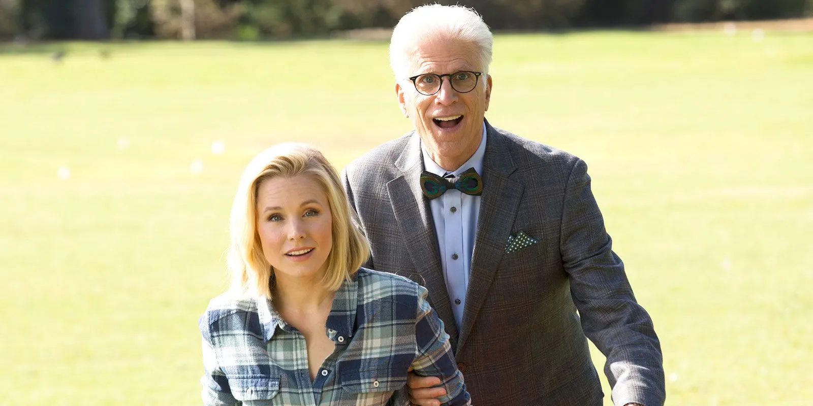 Eleanor and Chidi smiling and standing on the grass in The Good Place