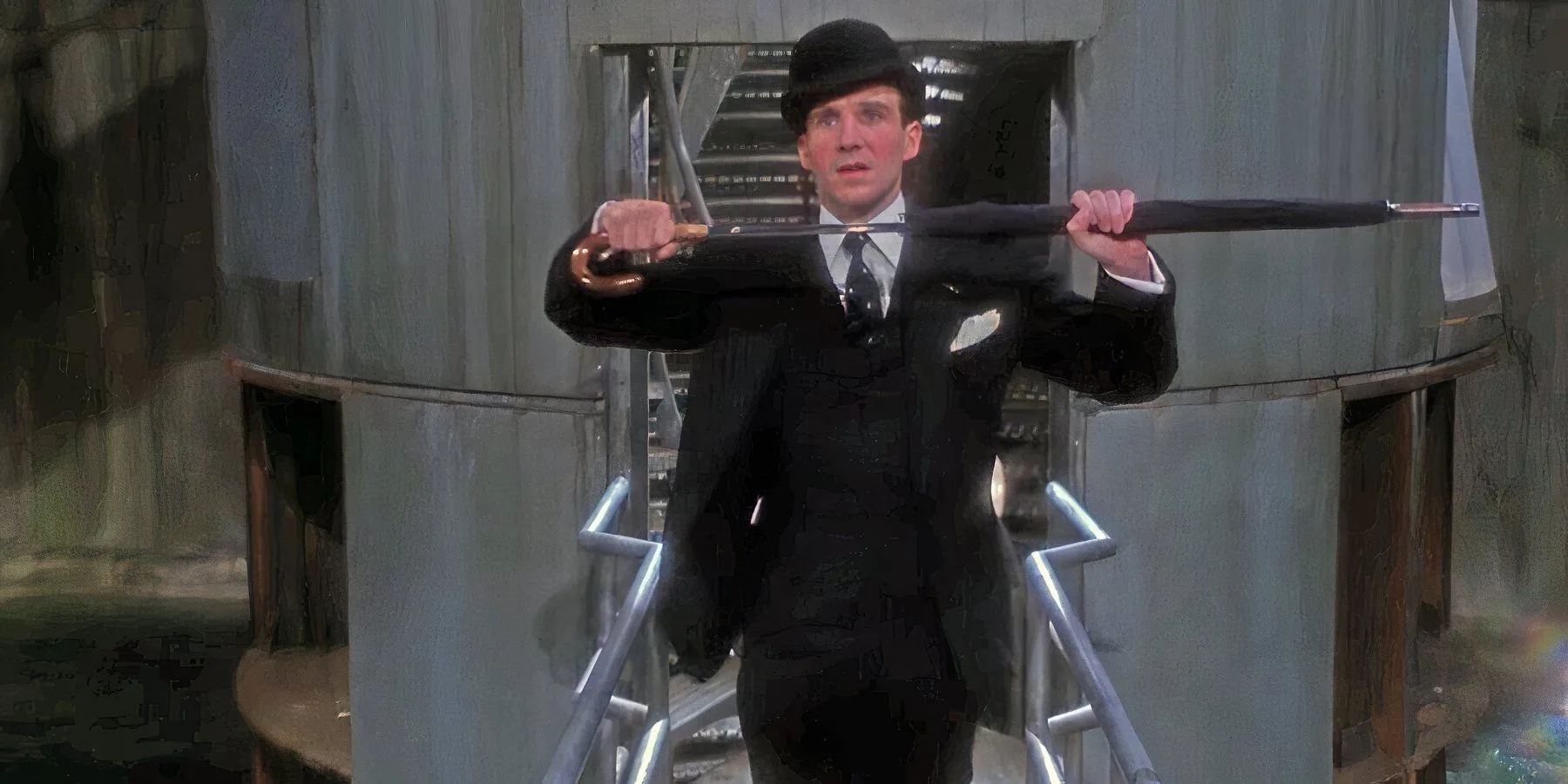 Ralph Fiennes as John Steed pulling a sword out of his umbrella in The Avengers 1998