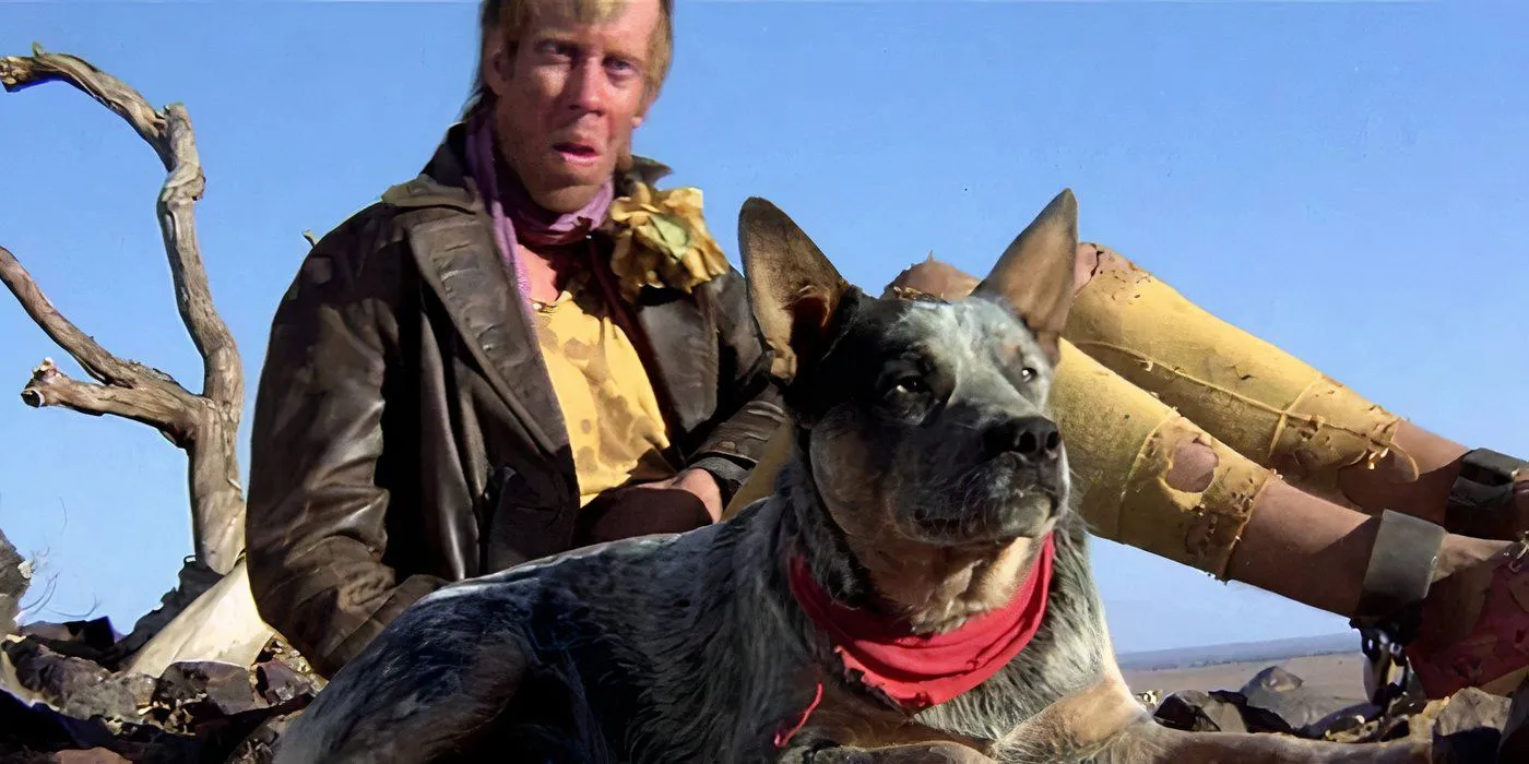 Bruce Spence as The Gyro Captain sitting with Max's Dog in Mad Max 2: The Road Warrior.