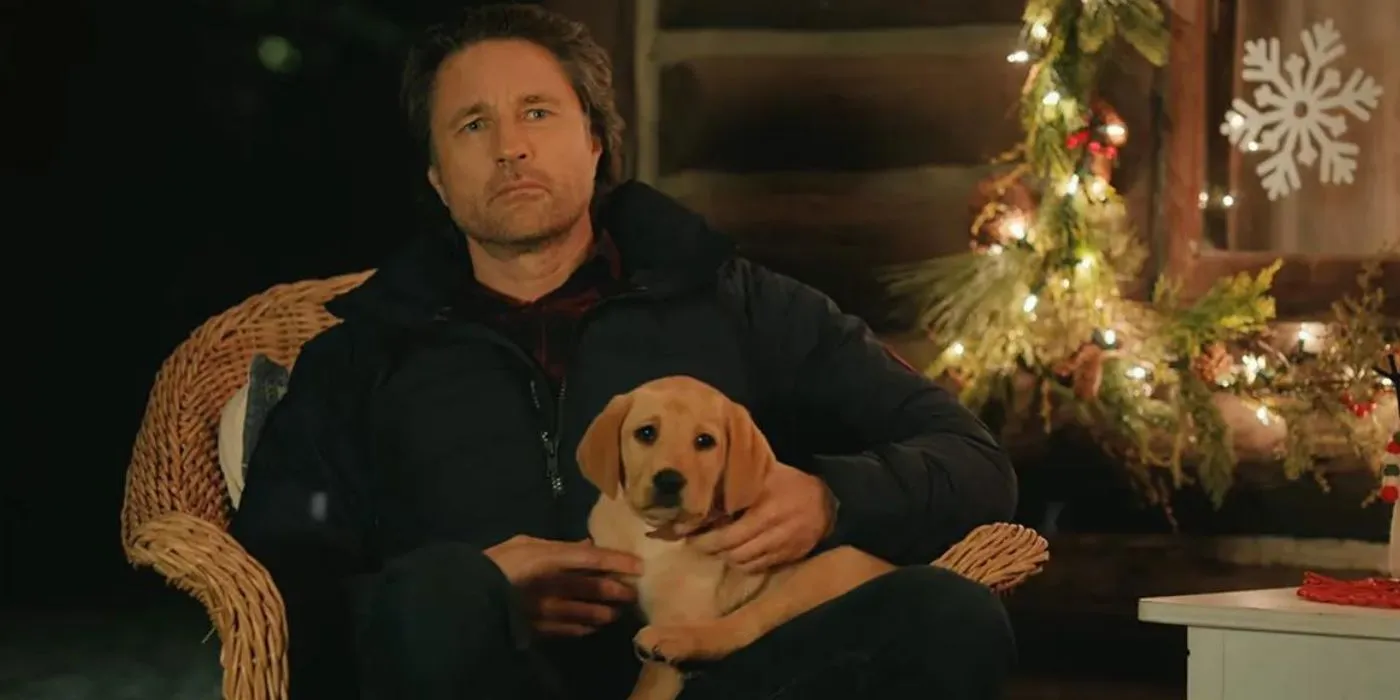 Jack sits with a Christmas puppy named Pony in Virgin River