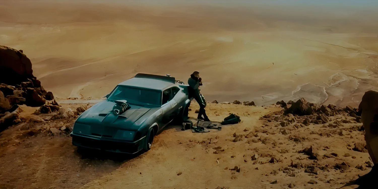 Jacob Tomuri as Mad Max leaning next to his Interceptor V8 in Furiosa