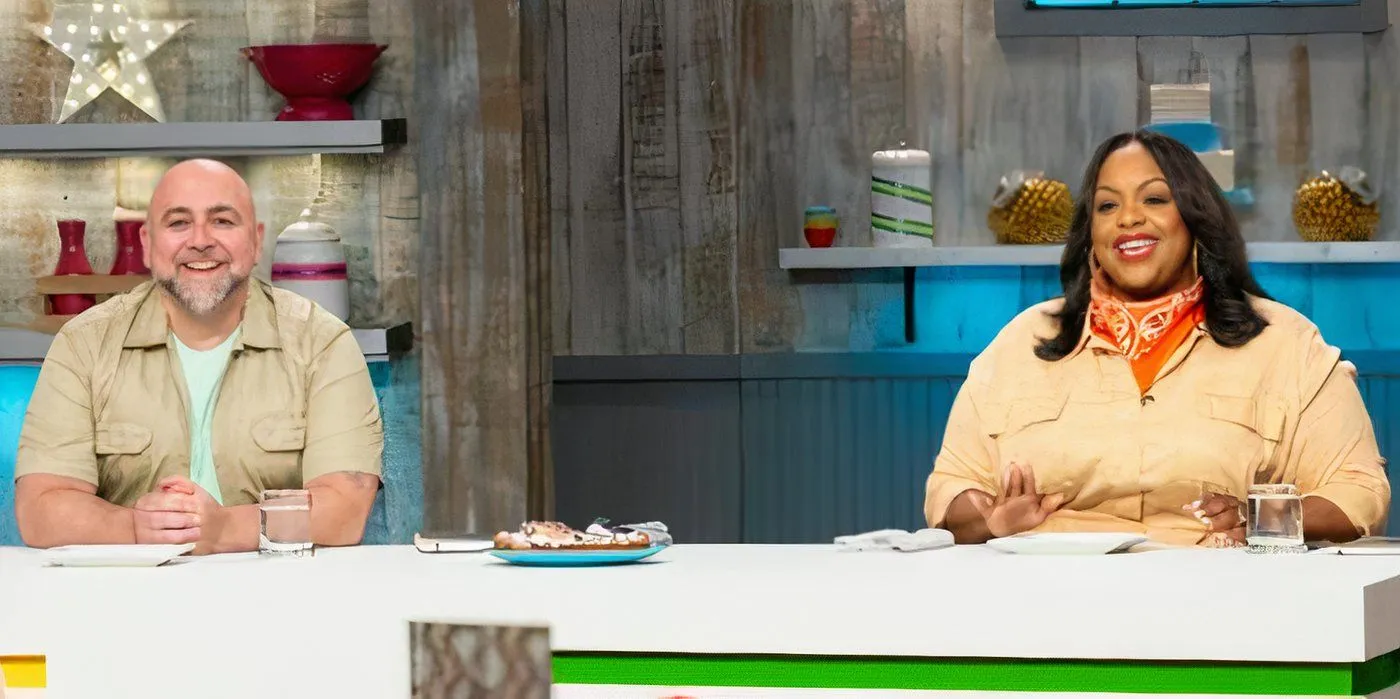 Kids Baking Championship Season 13 Hosts Duff Goldman and Kardea Brown Smiling At The Judges' Table