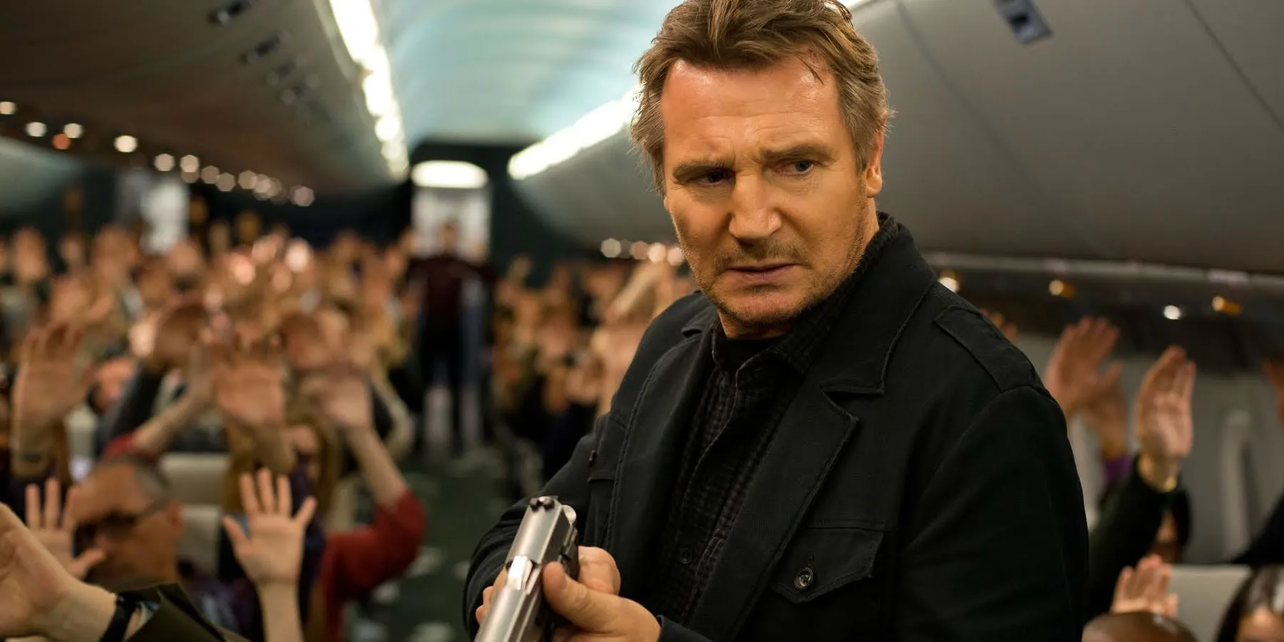 Liam Neeson holding a gun in Non-Stop