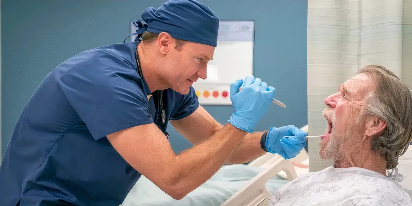 Josh Lawson nei panni di un medico che osserva la bocca di un paziente in St. Denis Medical