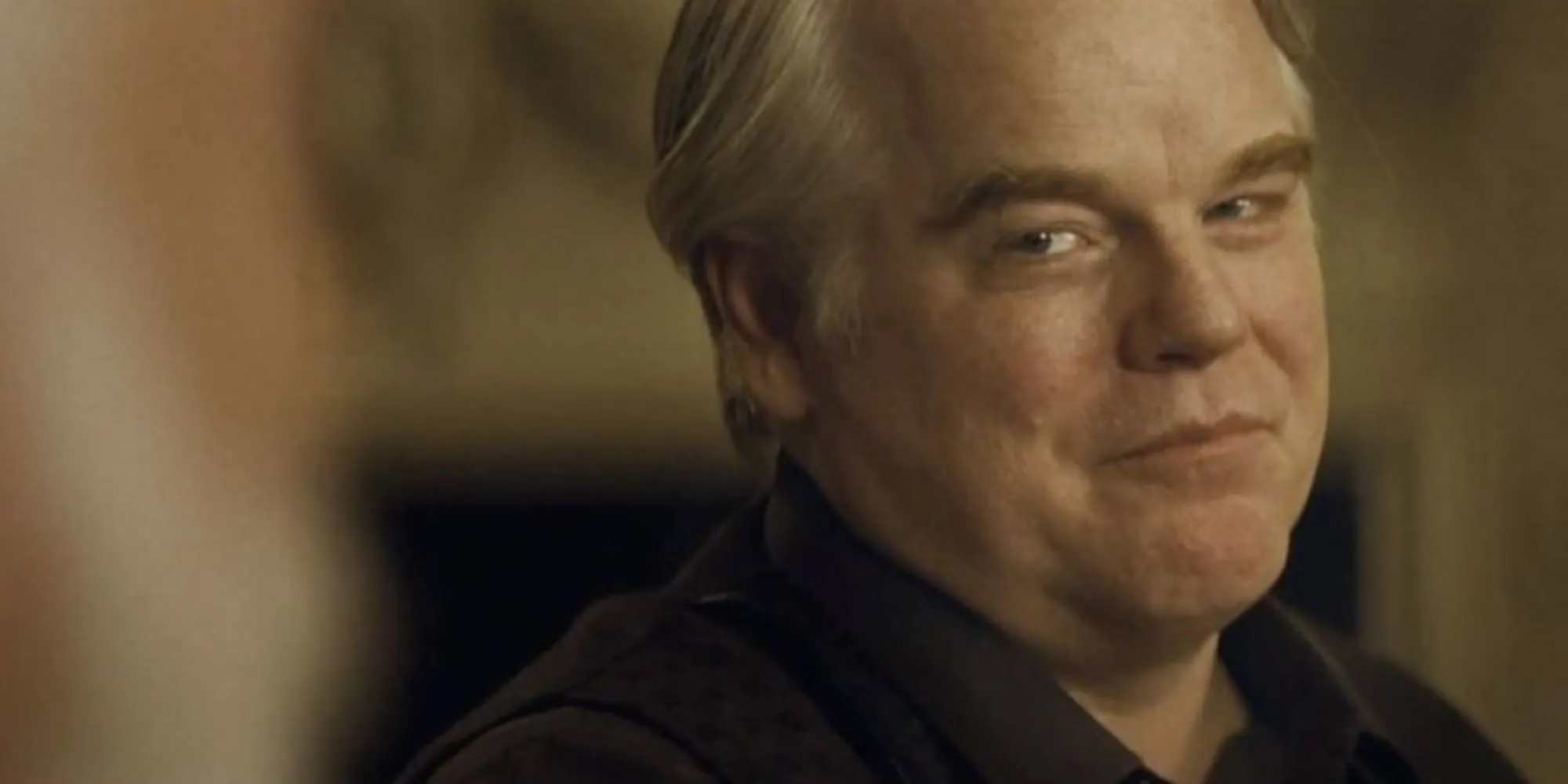 Philip Seymour Hoffman as Plutarch Heavensbee during a conversation with Donald Sutherland as President Snow in Hunger Games: Catching Fire