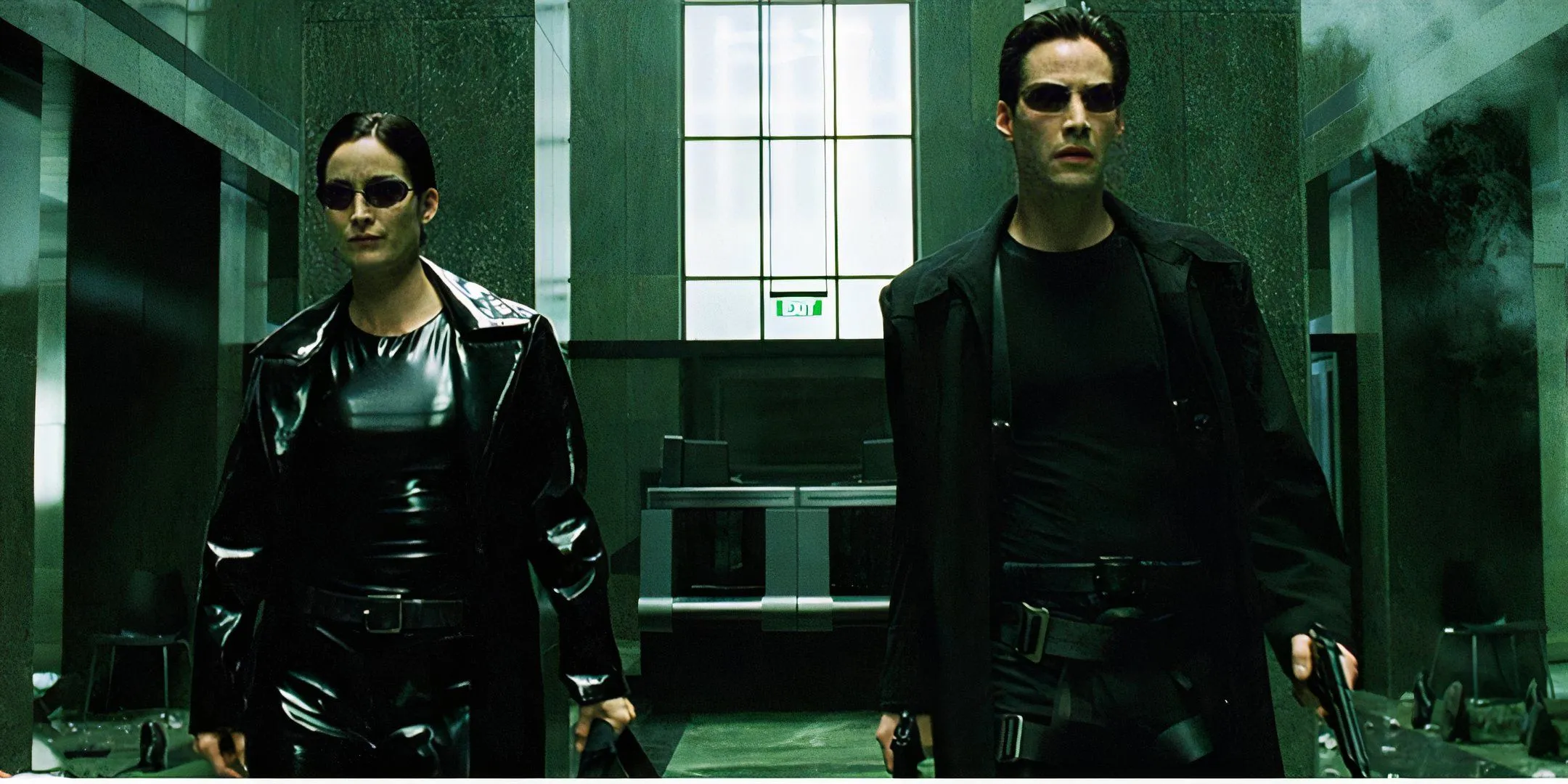 Trinity and Neo in The Matrix with lots of guns