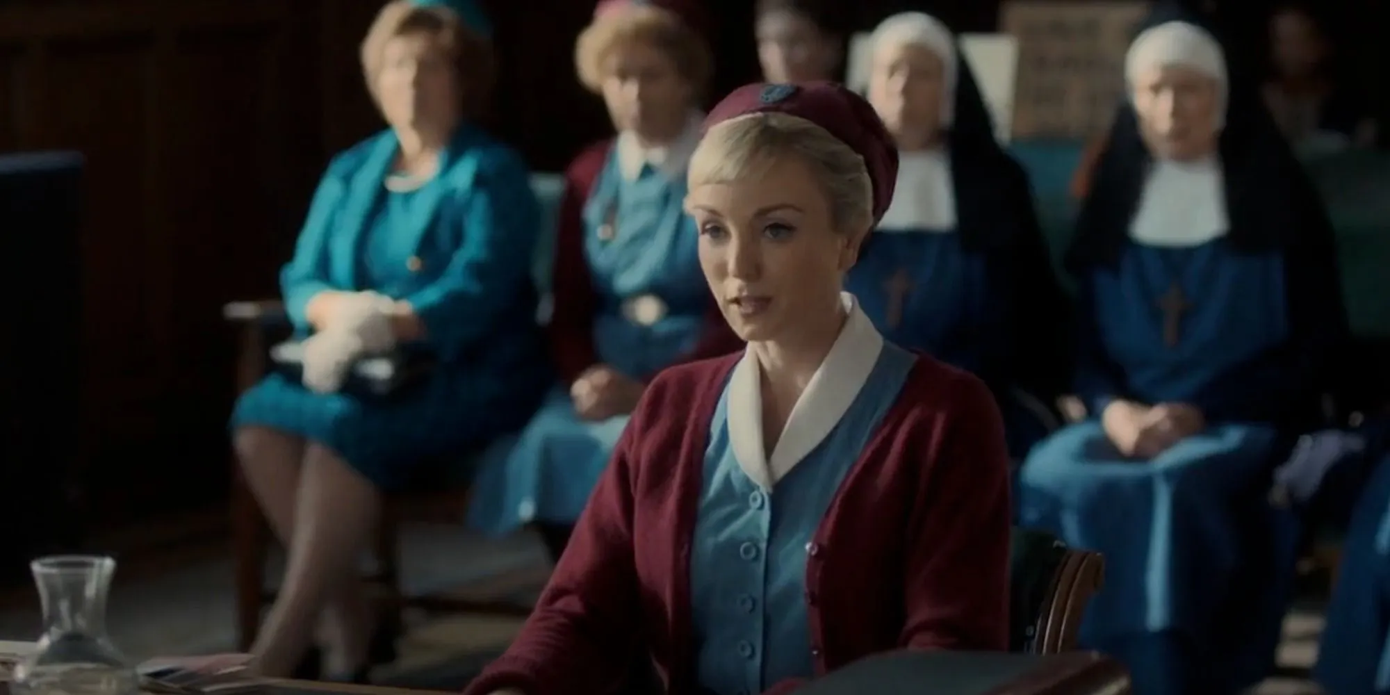 Trixie (Helen George) speaks to the board while the nuns and midwives of Nonnatus look on in Call the Midwife