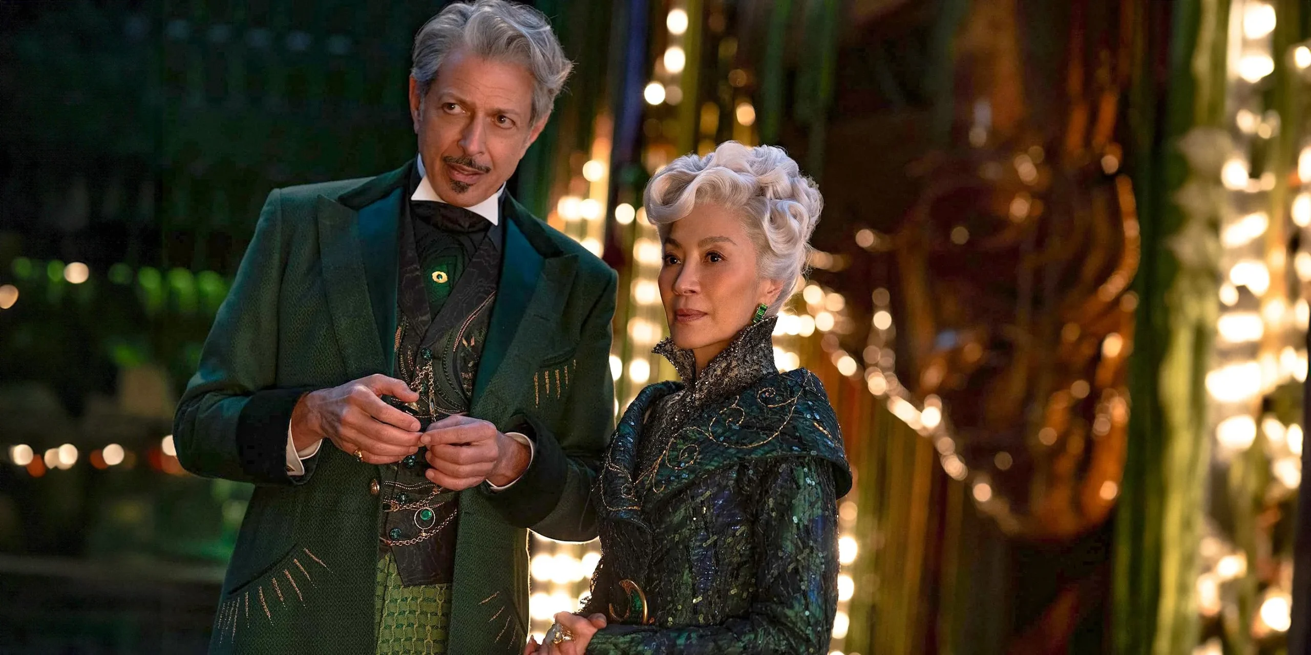 The Wizard (Jeff Goldblum) conversing with Madame Morrible (Michelle Yeoh) in Wicked