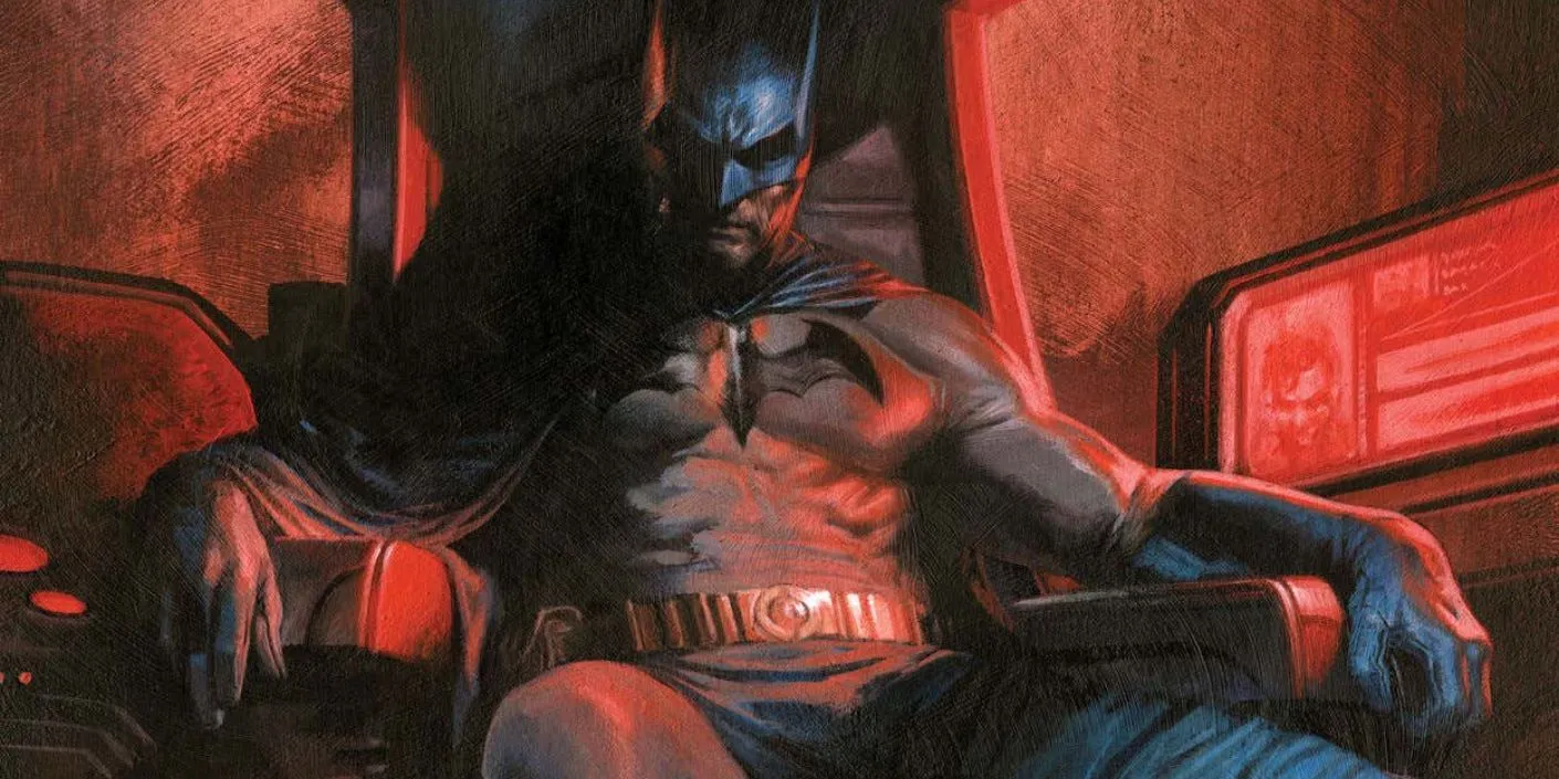 Batman sitting in his chair in the batcave