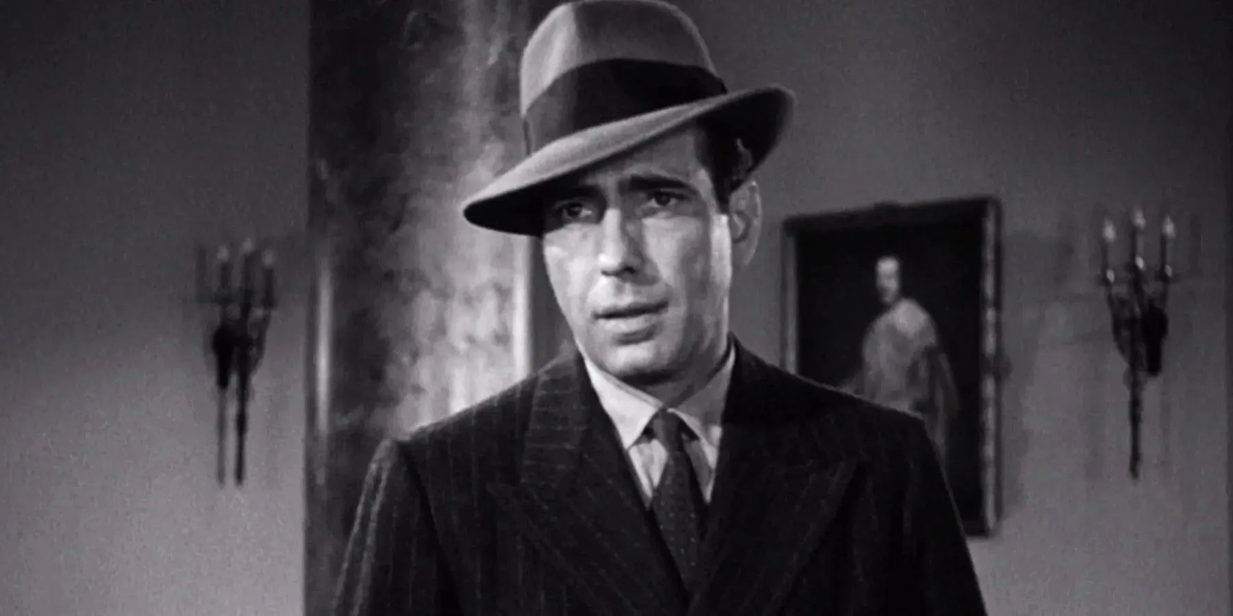 Humphrey Bogart jako Sam Spade wyglądający podejrzanie w filmie Sokół maltański