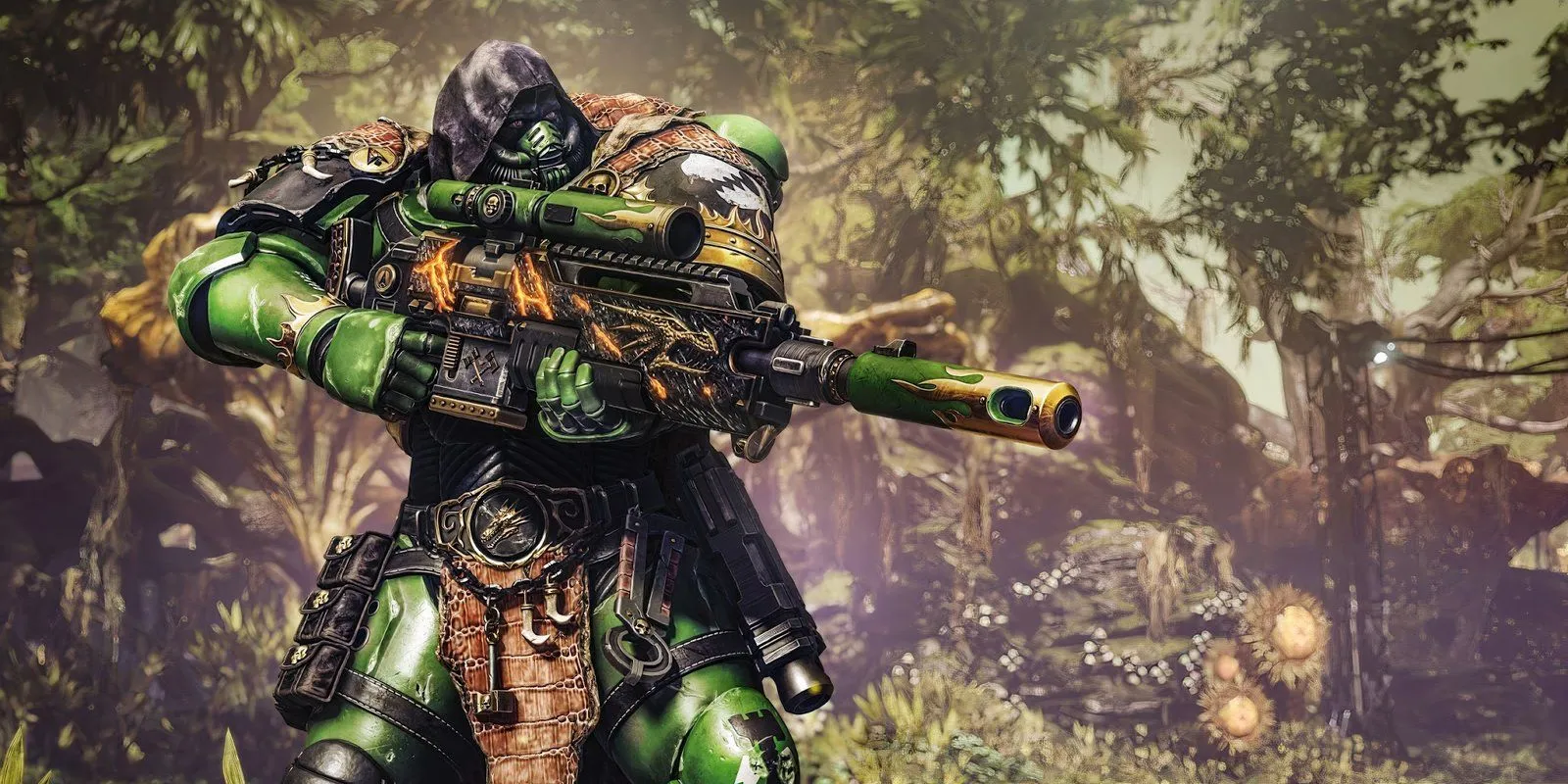 The Salamander Champion from Space Marine 2 holding a sniper rifle in front of a forest background