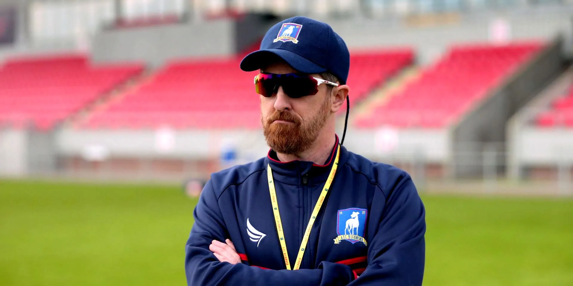 Coach Beard wearing sunglasses and standing on pitch in Ted Lasso Coach Beard wearing sunglasses and standing on pitch in Ted Lasso