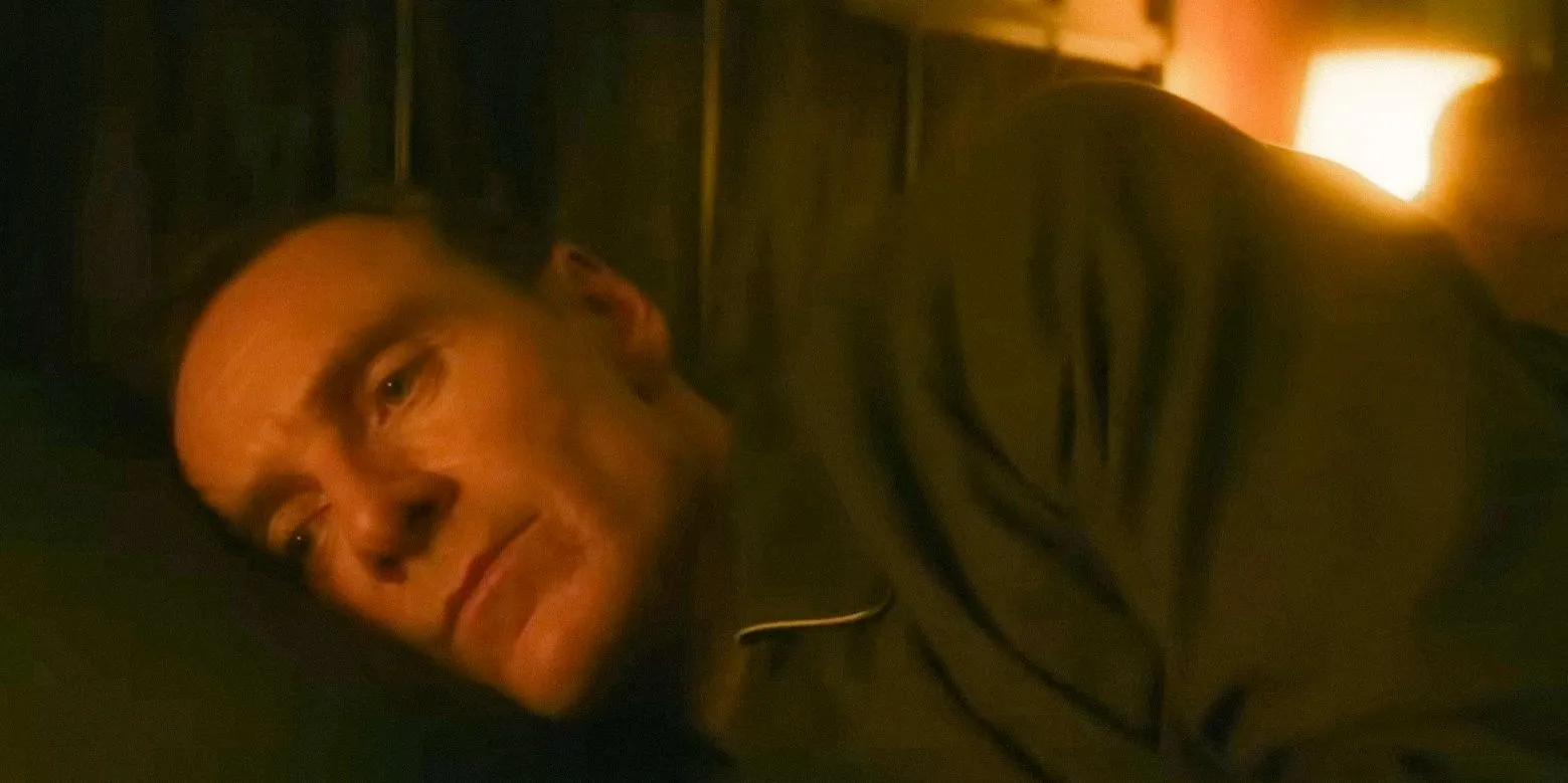 George Woodhouse (Michael Fassbender) lying down with a sad expression in Black Bag