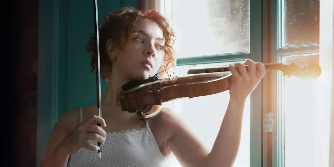 Martina playing the violin in Caught Martina playing the violin in Caught