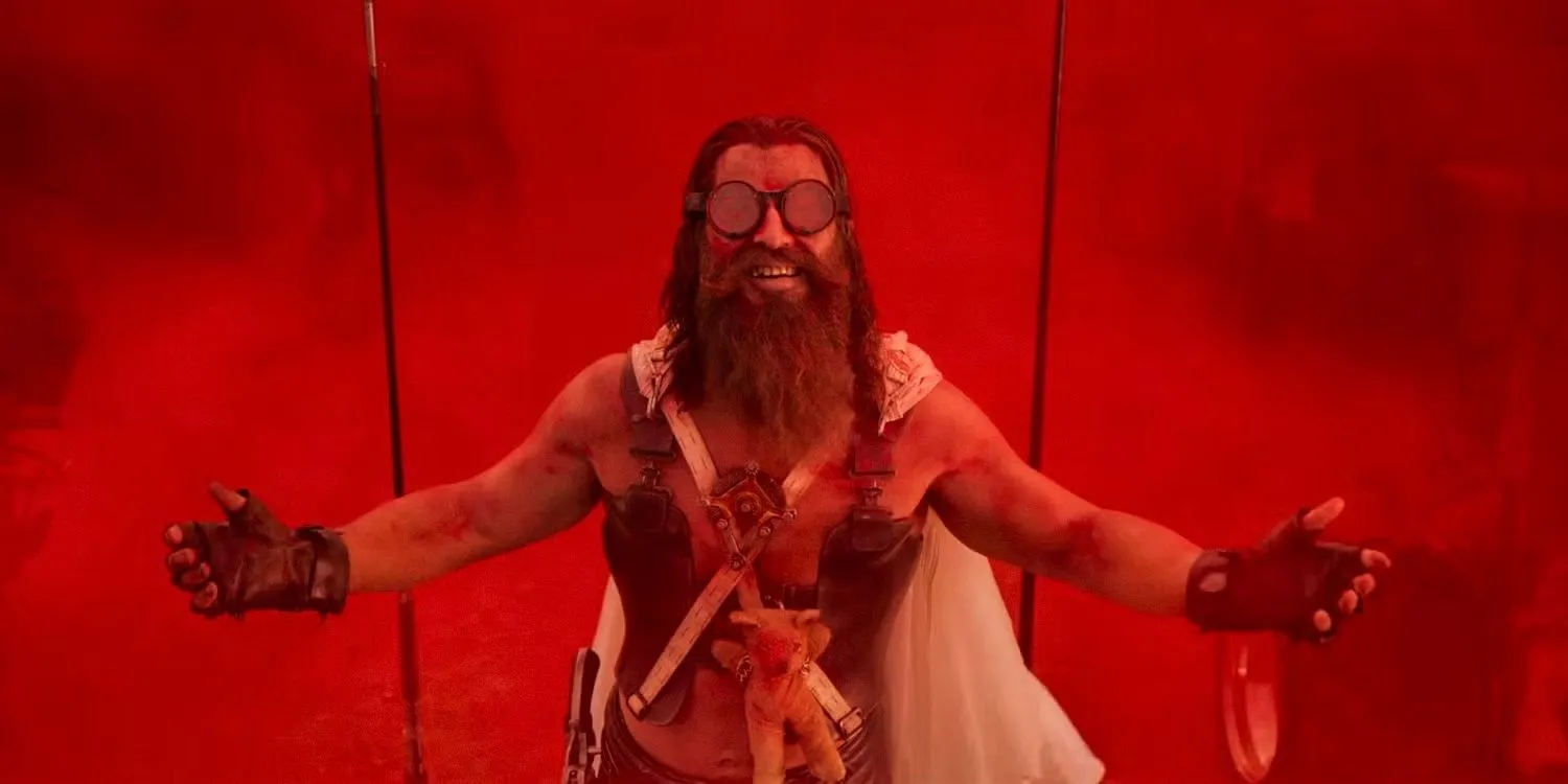 Chris Hemsworth surrounded by red smoke in Furiosa A Mad Max Saga Chris Hemsworth surrounded by red smoke in Furiosa A Mad Max Saga