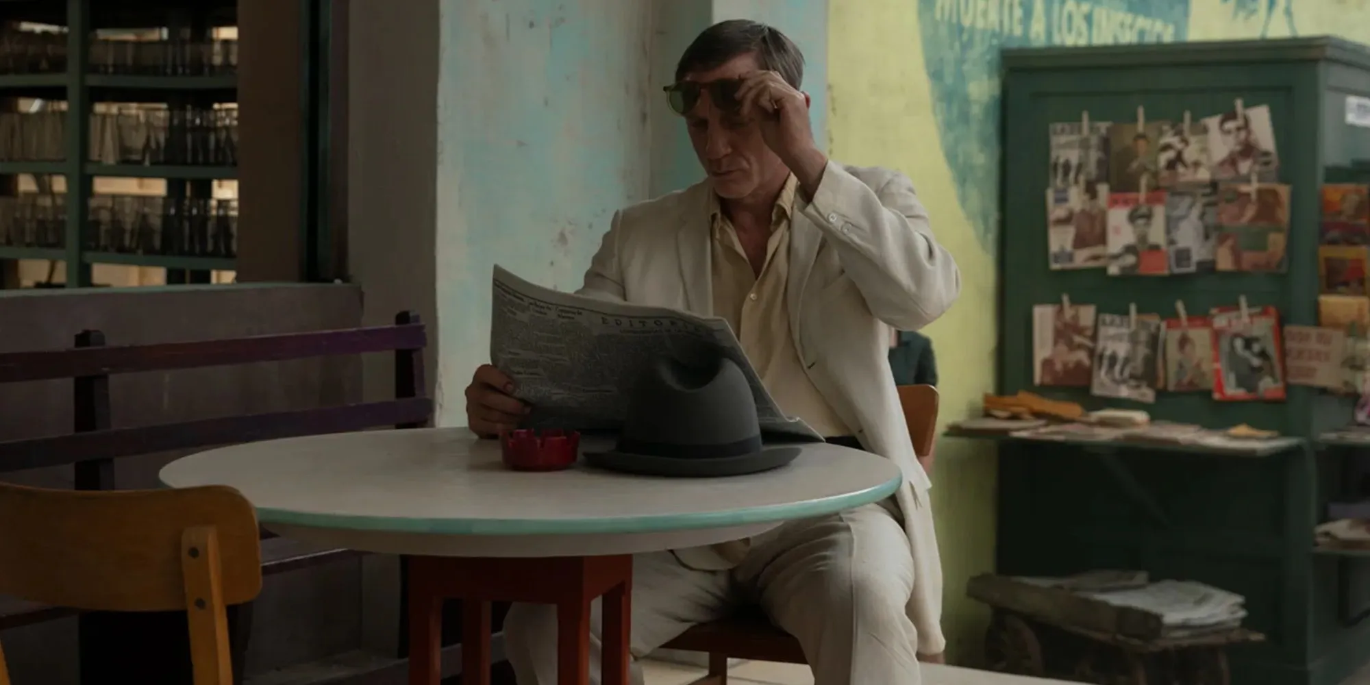 Daniel Craig reading a paper in Queer