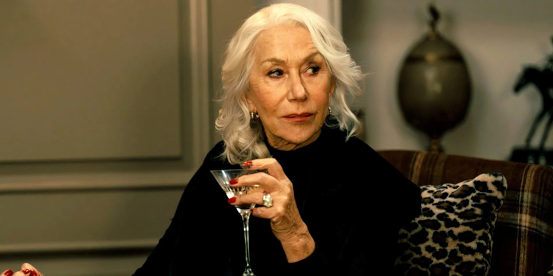 Helen Mirren holding a glass martini in MobLand
