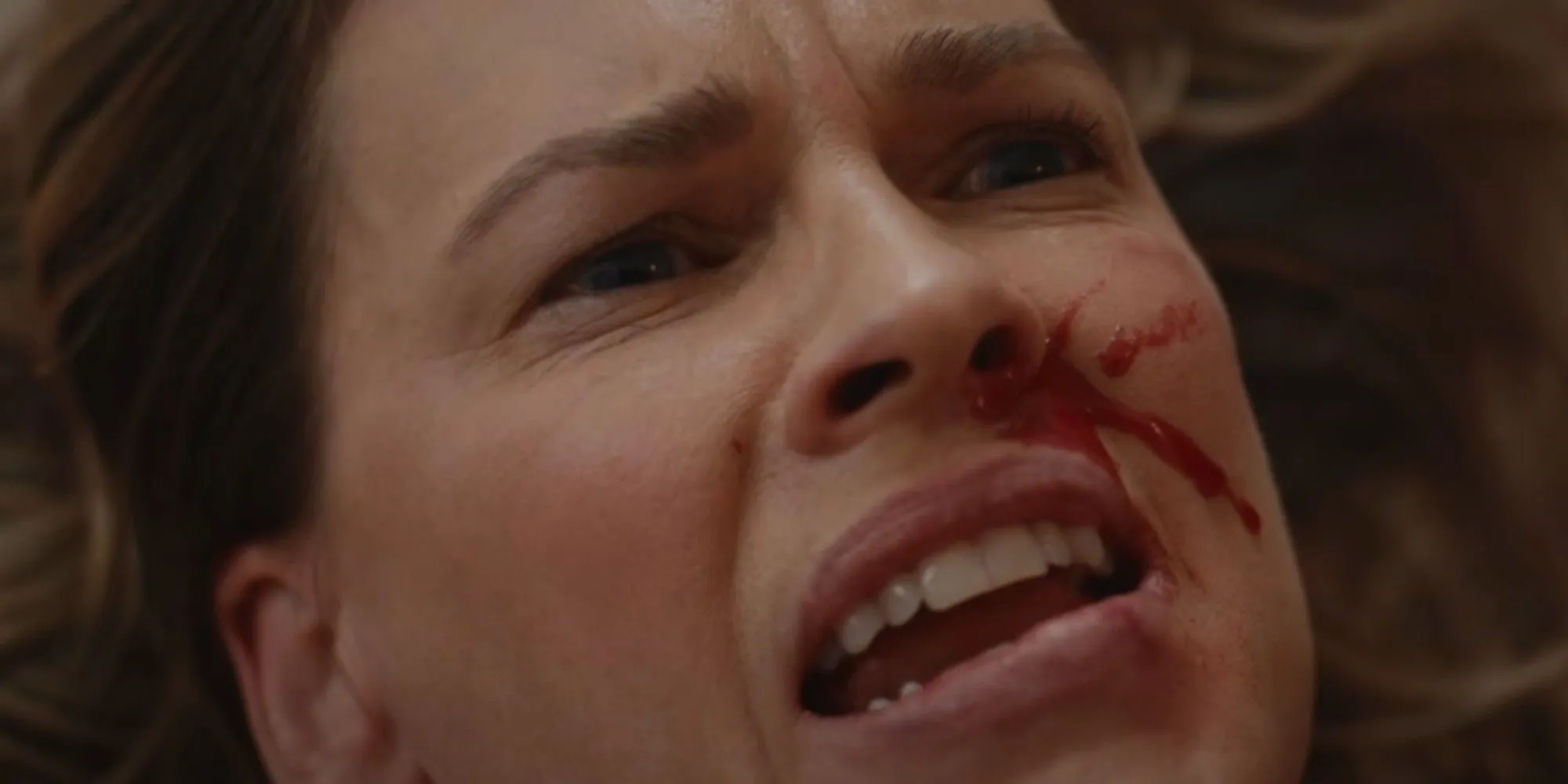 Hilary Swank looking scared with blood on her face in Yellowjackets season 3