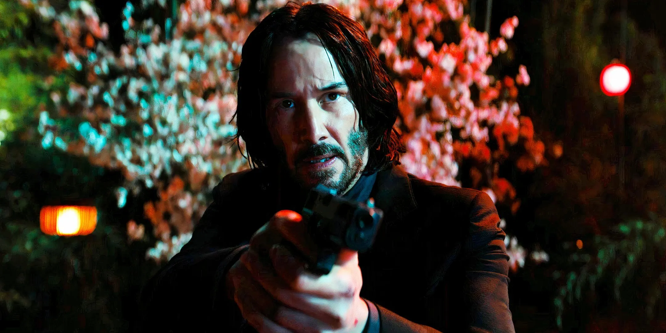 Keanu Reeves holding a pistol as John Wick in John Wick Chapter 4 Keanu Reeves holding a pistol as John Wick in John Wick Chapter 4