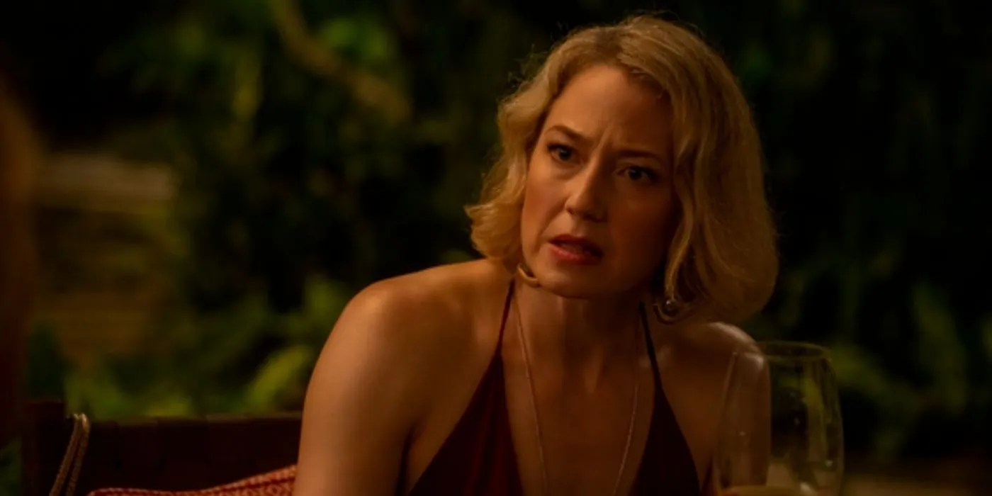 Laurie (Carrie Coon) looking angry as she eats dinner in The White Lotus season 3 episode 7.
