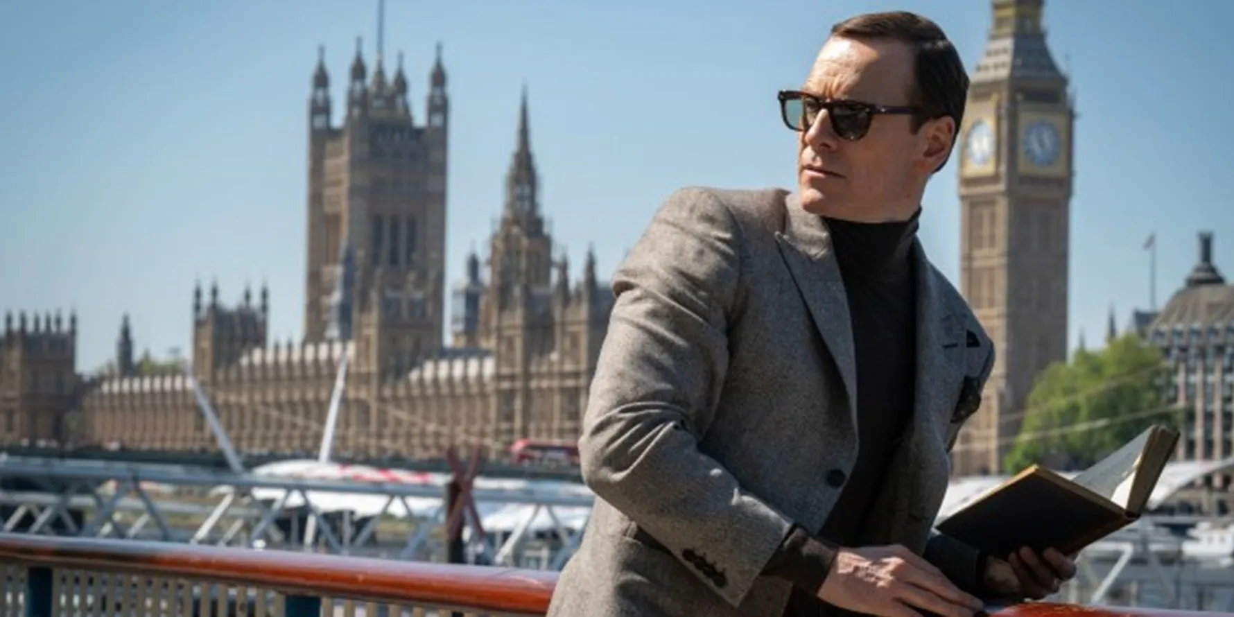 Michael Fassbender reading a book in Black Bag