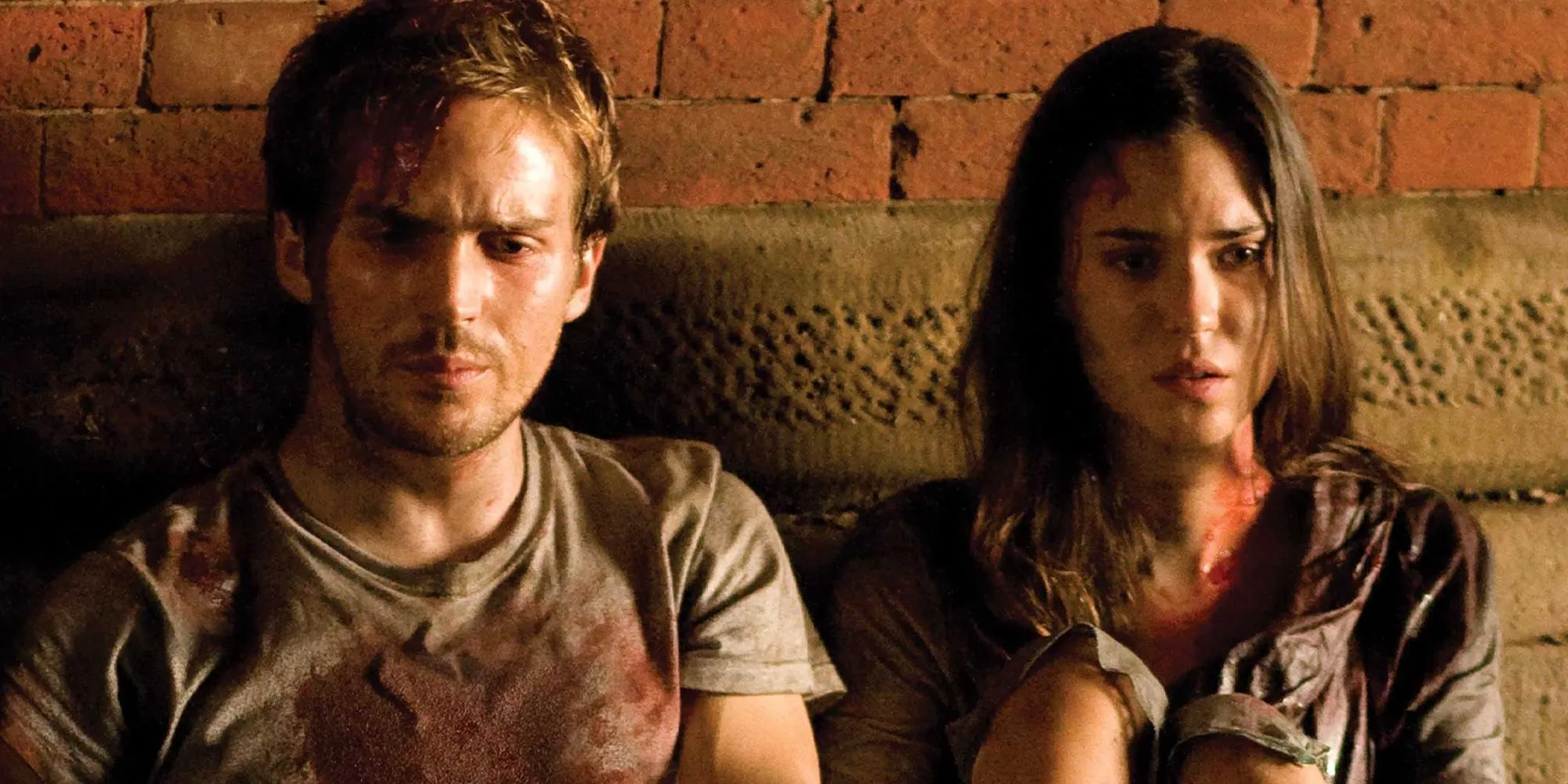 Rob and Beth looking distressed against a brick backdrop in Cloverfield Rob and Beth looking distressed against a brick backdrop in Cloverfield