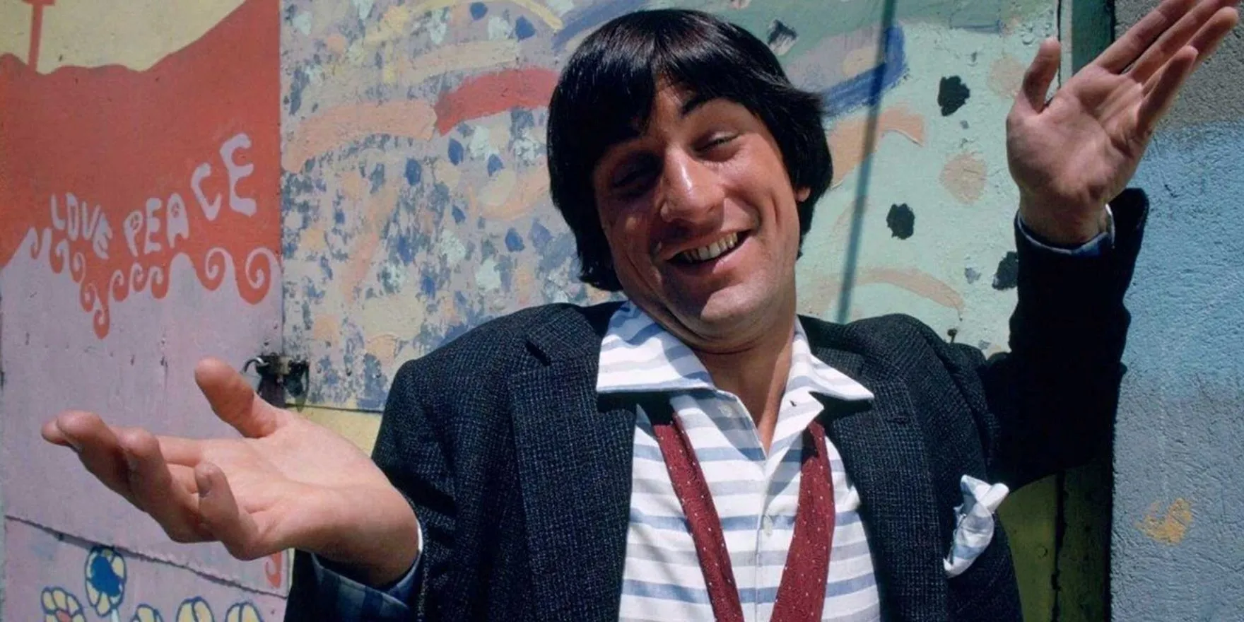Robert De Niro shrugging in The Gang That Couldn't Shoot Straight. Robert De Niro shrugging in The Gang That Couldn't Shoot Straight.