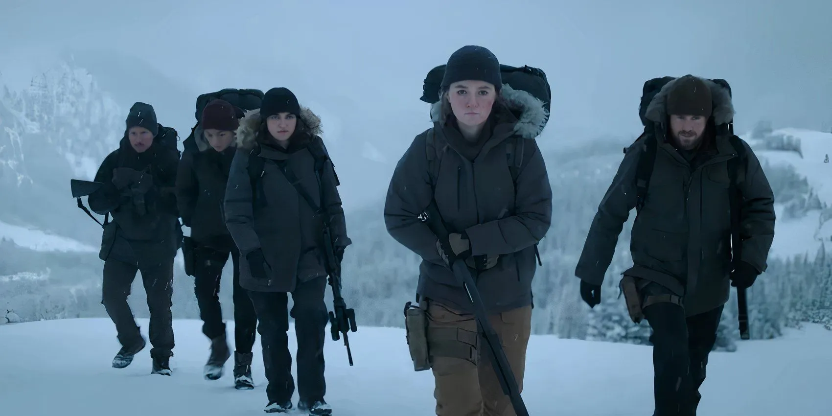 Group of armed individuals in snowy surroundings from The Last of Us