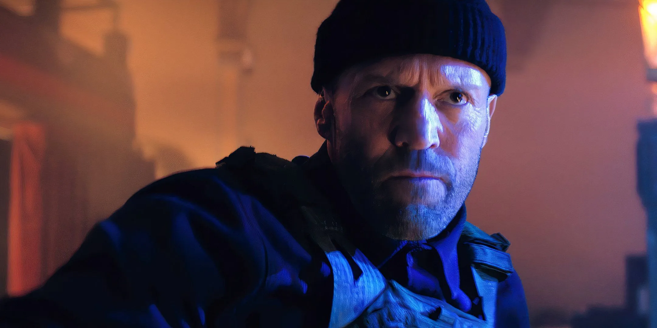 Jason Statham wearing a beanie and scowling in A Working Man Jason Statham wearing a beanie and scowling in A Working Man