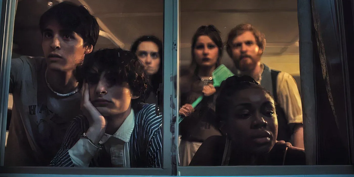 A group of teens standing around a window in Hell of a Summer A group of teens standing around a window in Hell of a Summer