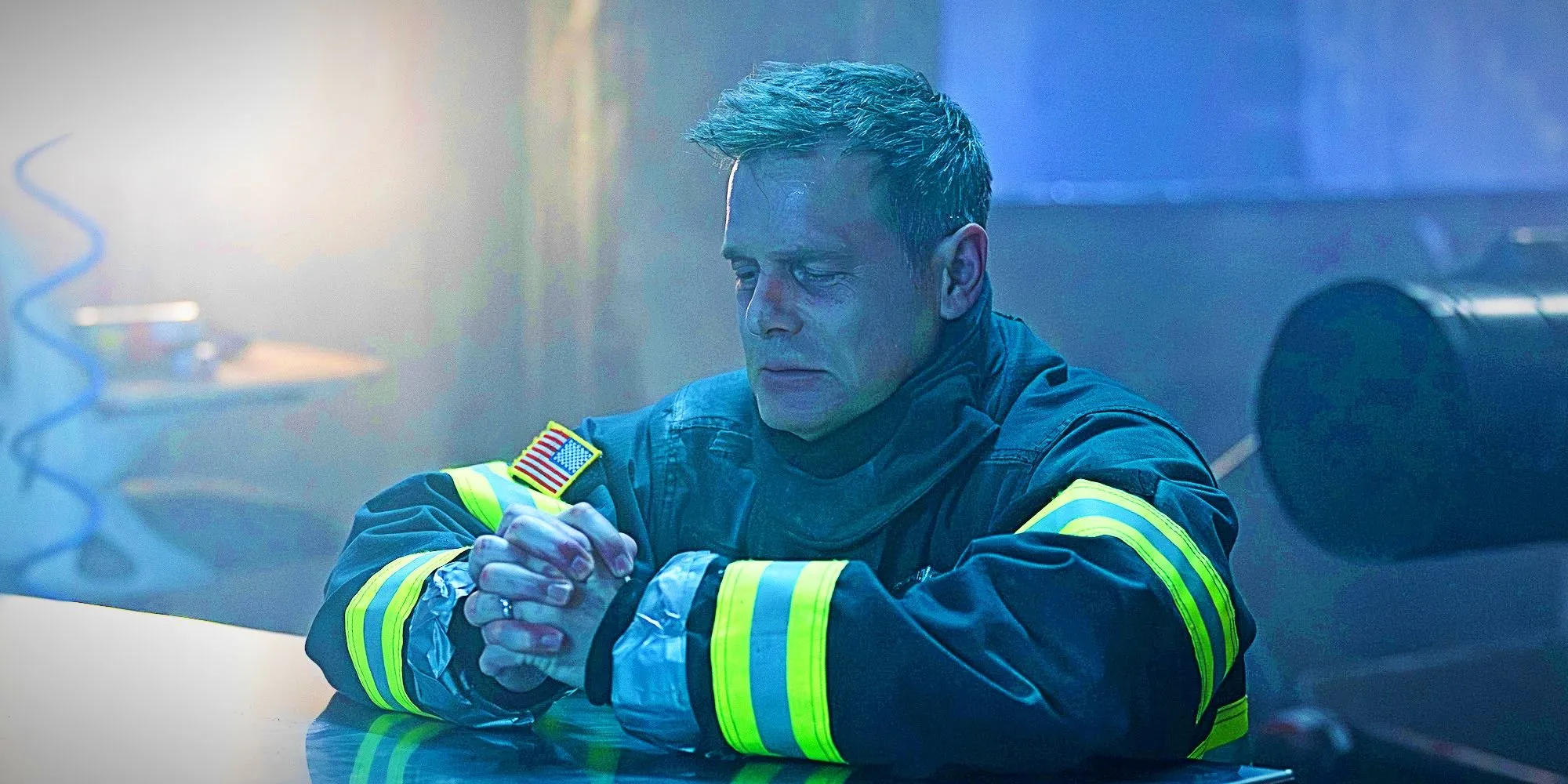 Peter Krause kneeling in prayer as Bobby Nash in 9-1-1 season 8, episode 15.