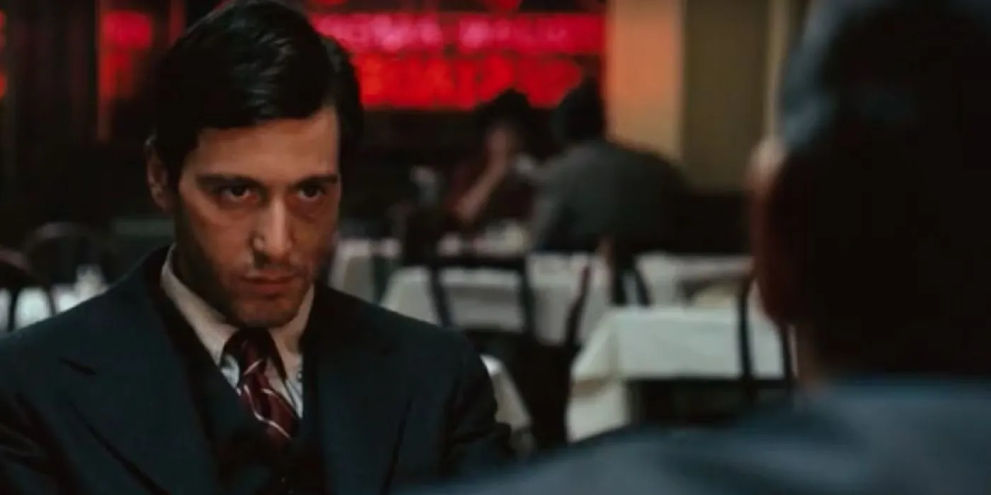 Al Pacino as Michael staring intently in a restaurant in The Godfather. Al Pacino as Michael staring intently in a restaurant in The Godfather.