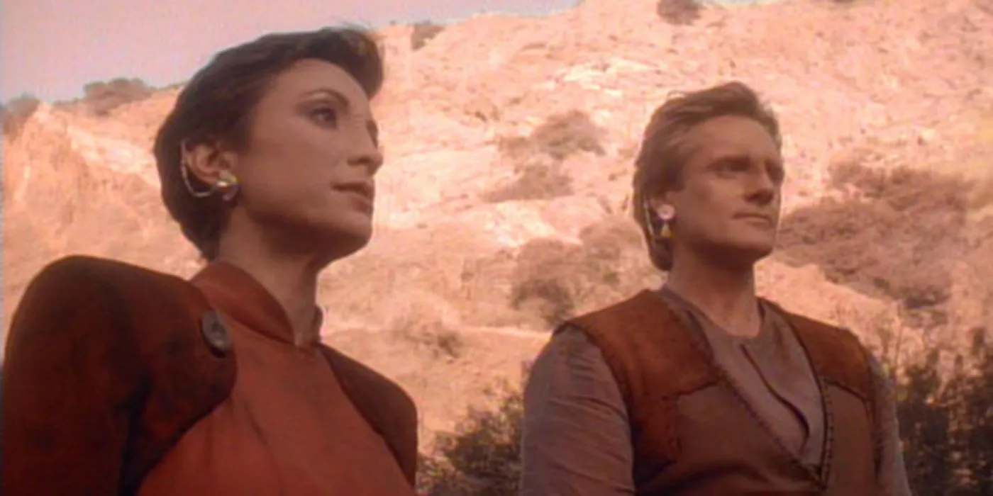 Kira and Shakaar from Star Trek: Deep Space Nine stare off-camera on a desert planet. Kira and Shakaar from Star Trek: Deep Space Nine stare off-camera on a desert planet.