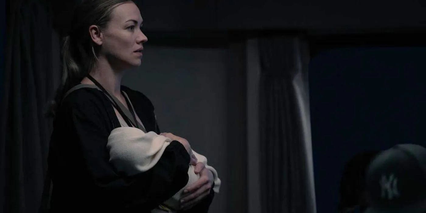 Serena Joy Waterford holding a baby and looking scared in The Handmaid's Tale Season 5.