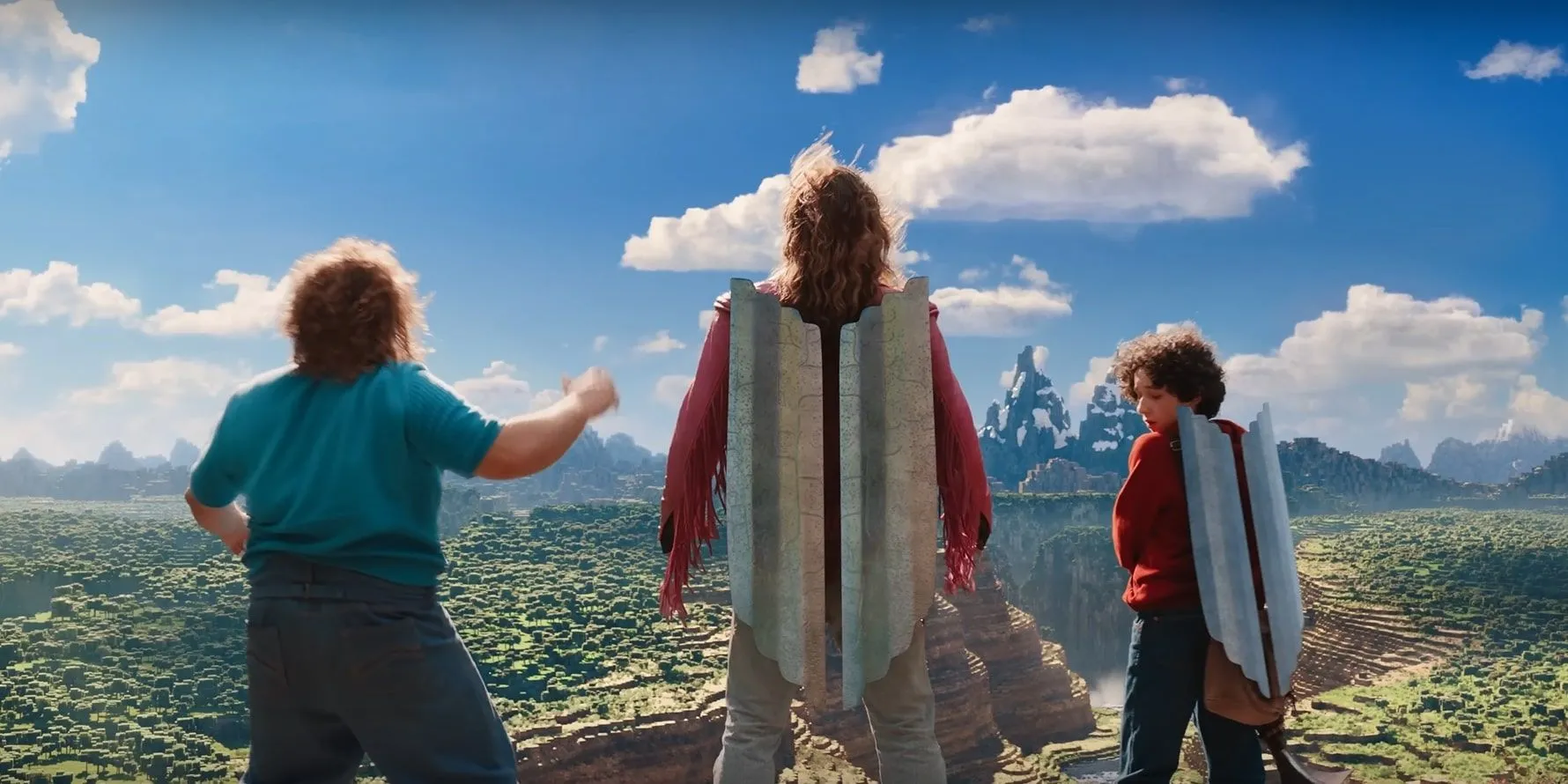 Jack Black as Steve standing next to Jason Momoa as Garrett and Sebastian Hansen as Henry with elytras on in A Minecraft Movie Jack Black as Steve standing next to Jason Momoa as Garrett and Sebastian Hansen as Henry with elytras on in A Minecraft Movie
