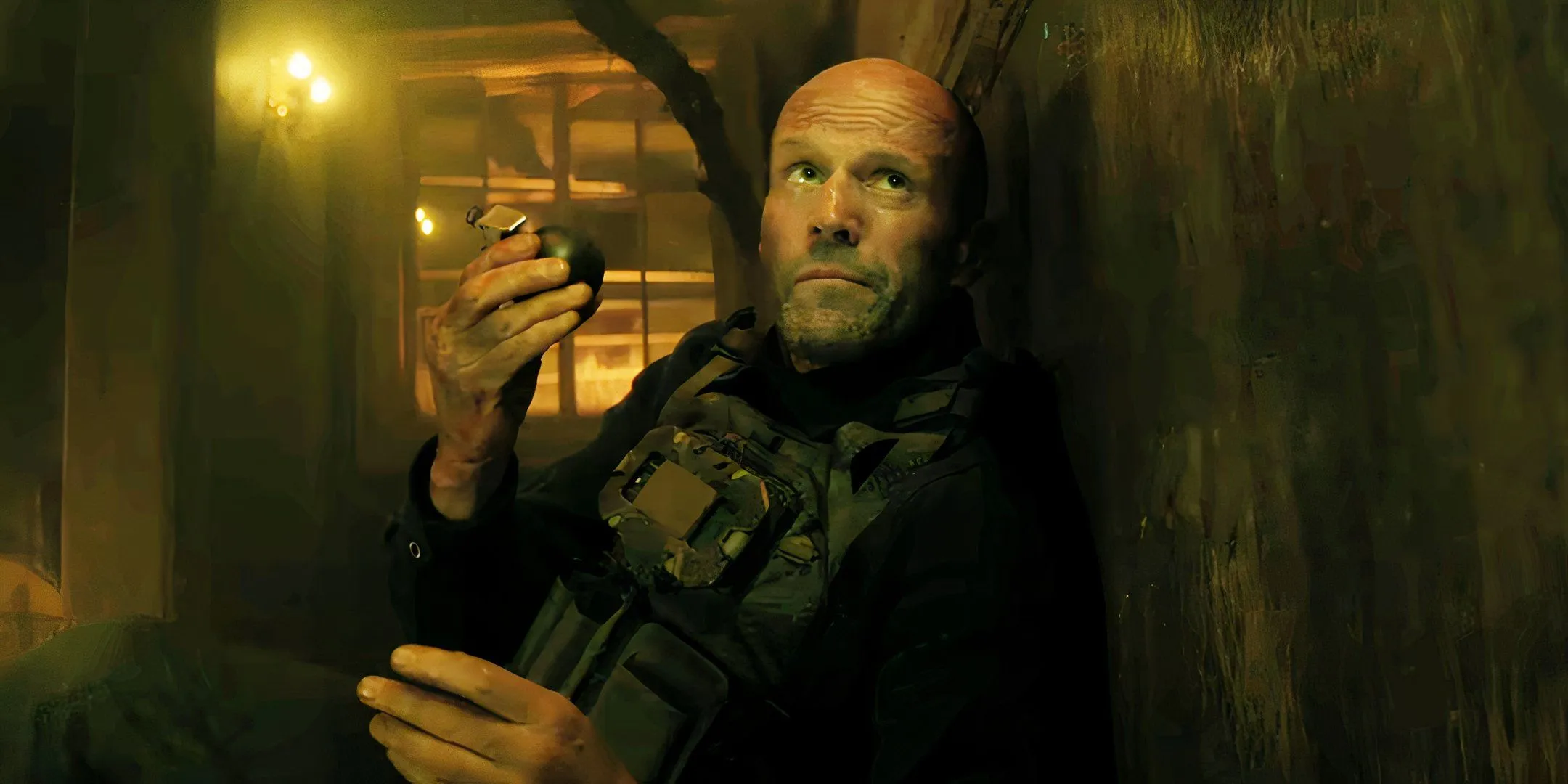 Jason Statham holding a grenade in A Working Man Jason Statham holding a grenade in A Working Man