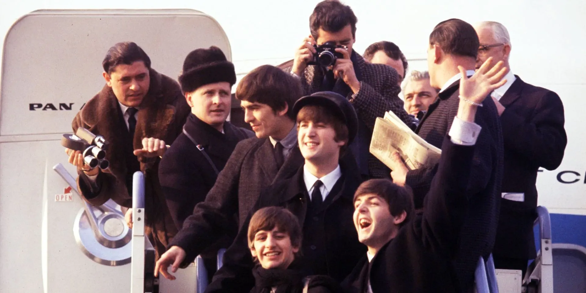 The Beatles outside their plane